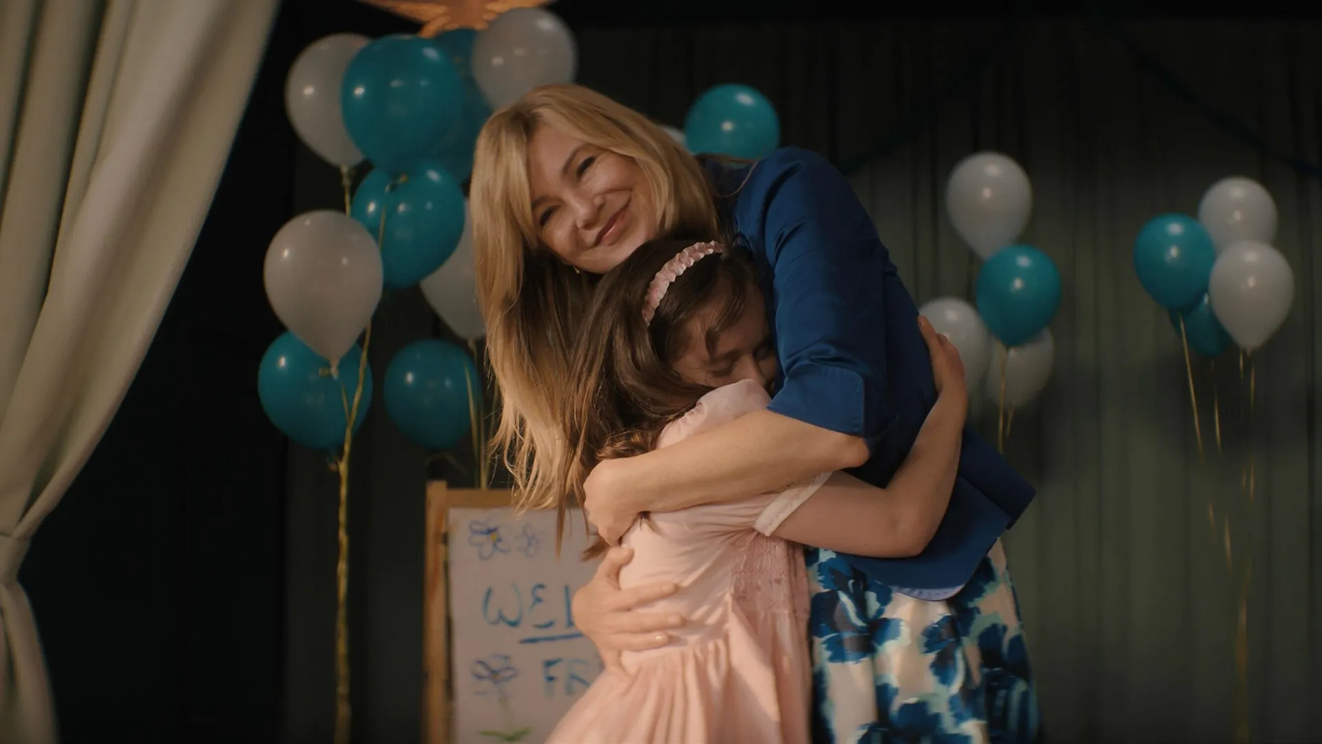 Kristine Barnett (Ellen Pompeo) hugs her adopted daughter.