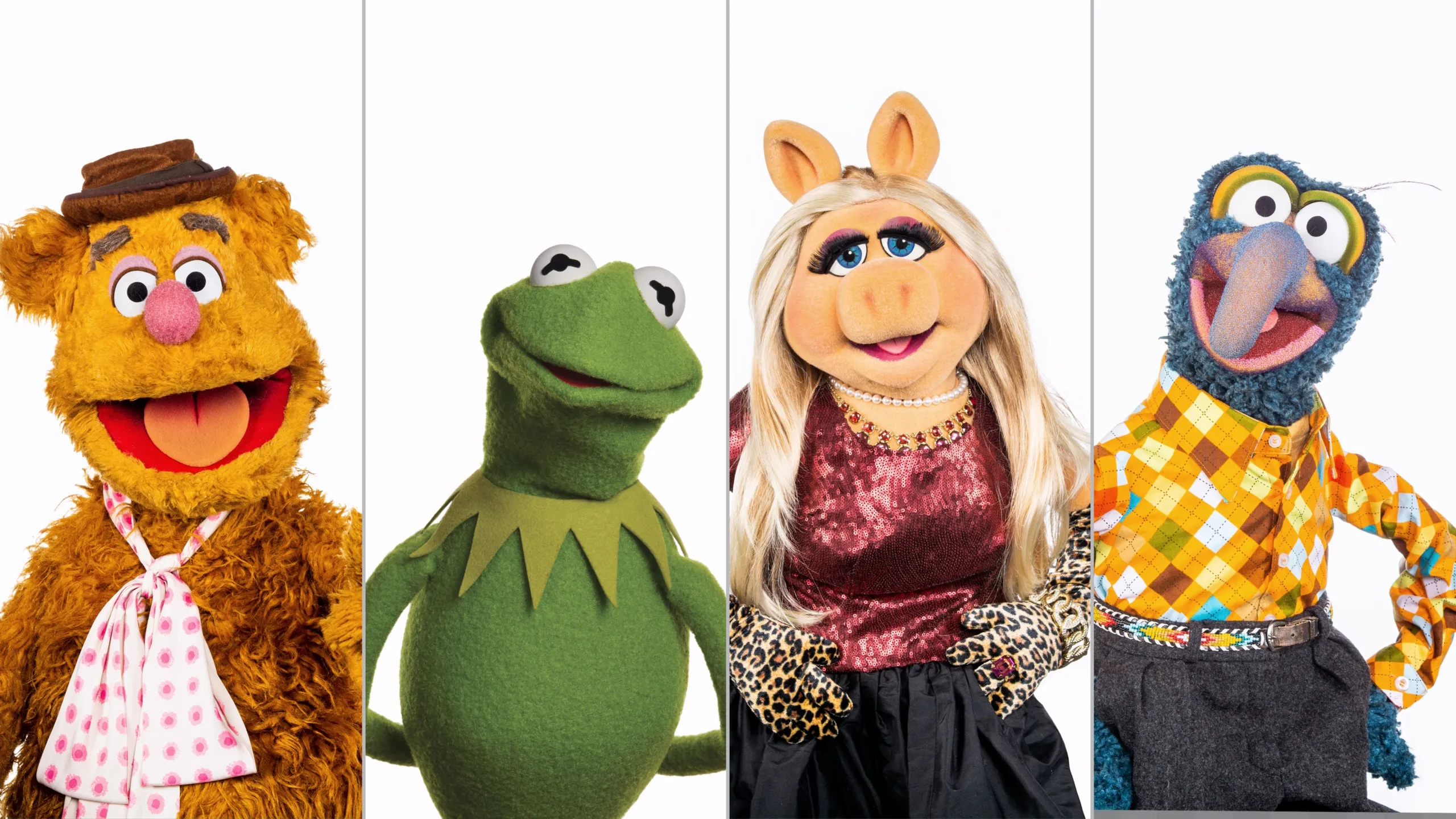 Fozzie Bear, Kermit the Frog, Miss Piggy, and The Great Gonzo on a white background