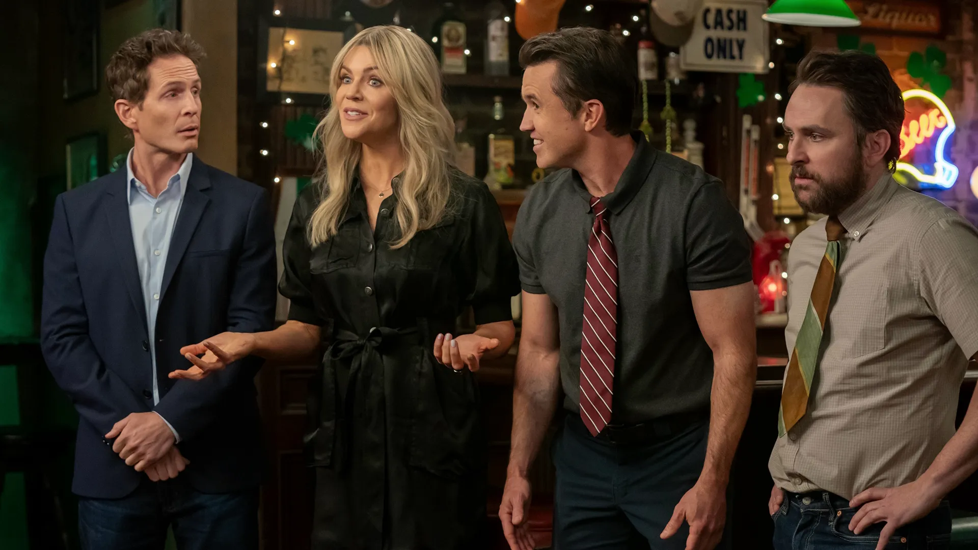 The Gang (Dennis, Dee, Mac, and Charlie) inside Paddy's Pub, talking to someone off-screen
