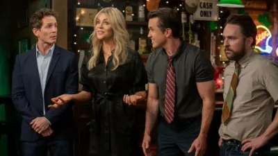 The Gang (Dennis, Dee, Mac, and Charlie) inside Paddy's Pub, talking to someone off-screen