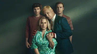 Maggie Murdaugh (Patricia Arquette) sits with Alex Murdaugh (Jason Clarke) embracing her with bloody hands. Their sons Paul (Johnny Berchtold) and Buster (Will Harrison) stand behind them