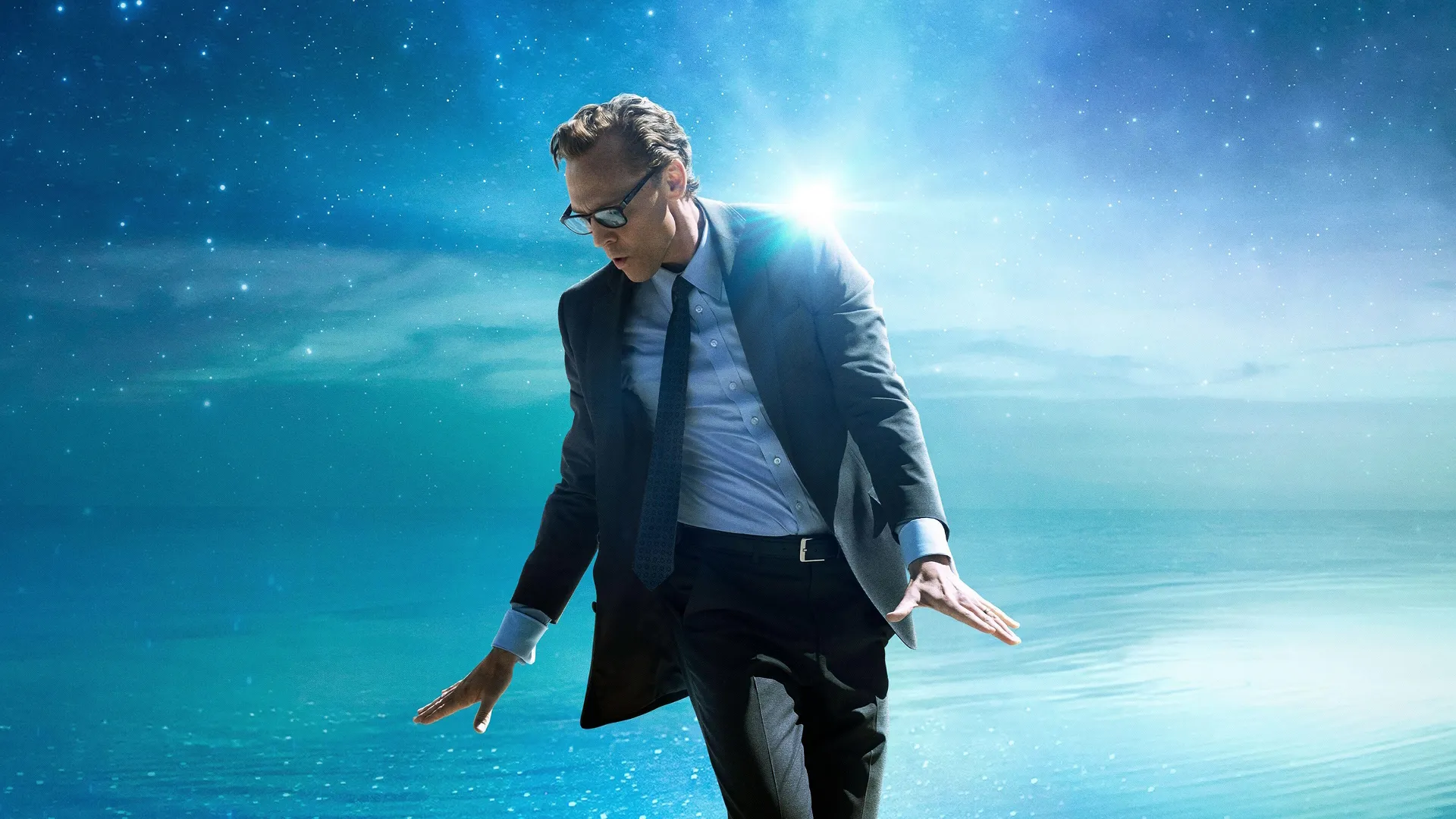 Charles "Chuck" Krantz (Tom Hiddleston) dancing against a blue backdrop.