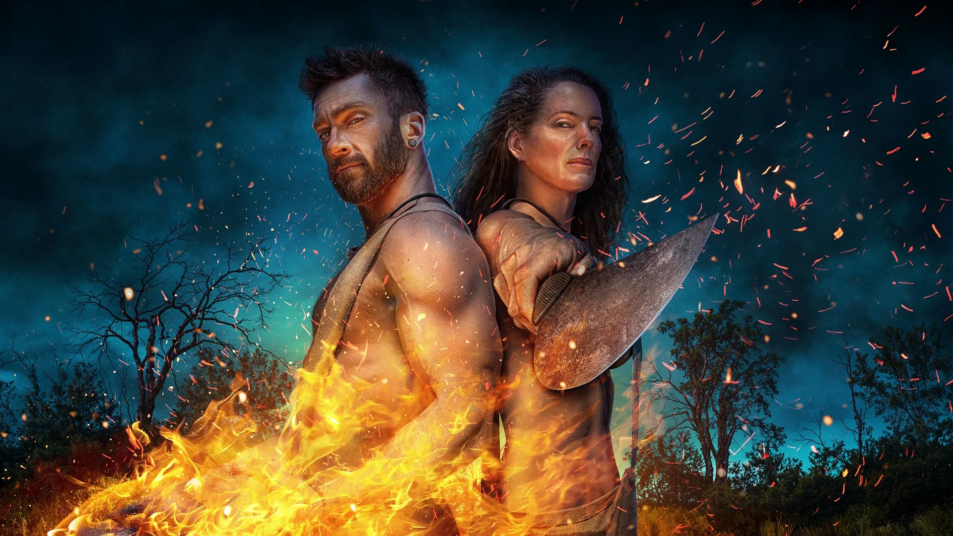 Promotional key art for Naked and Afraid featuring a man and woman standing in front of fire