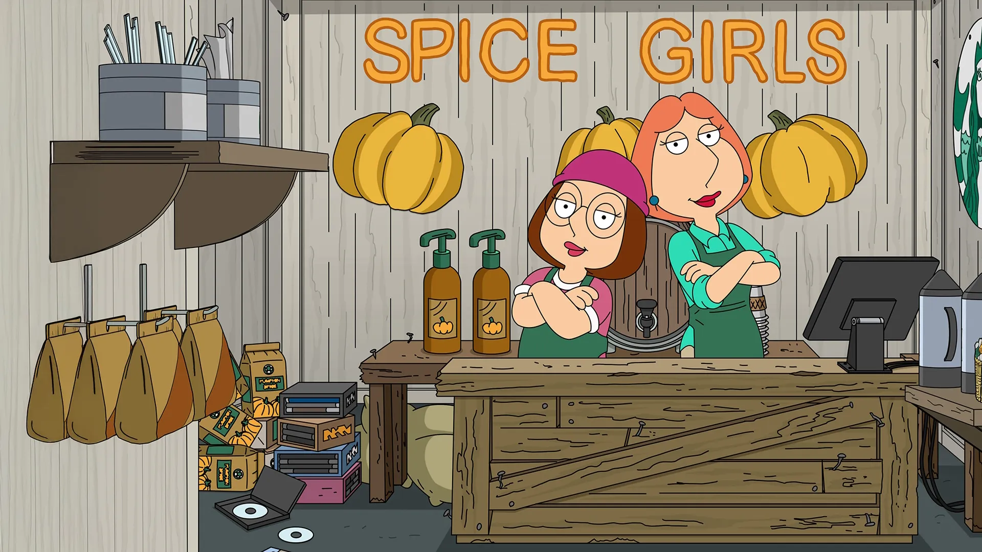 Meg and Lois pose together in a homemade shop, below a sign reading Spice Girls