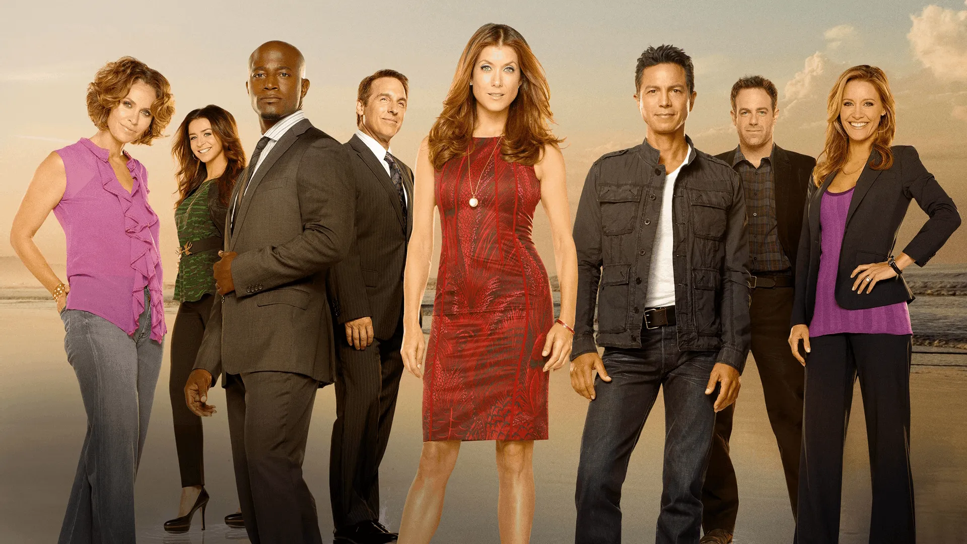 The main cast of the medical drama television series Private Practice poses for a promotional photograph on a beach during sunset.