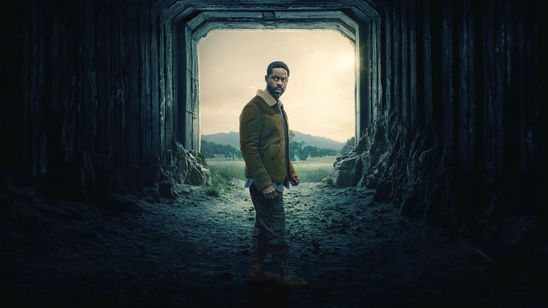 Xander (Sterling K. Brown) riding a horse through a clearing in a forested area.