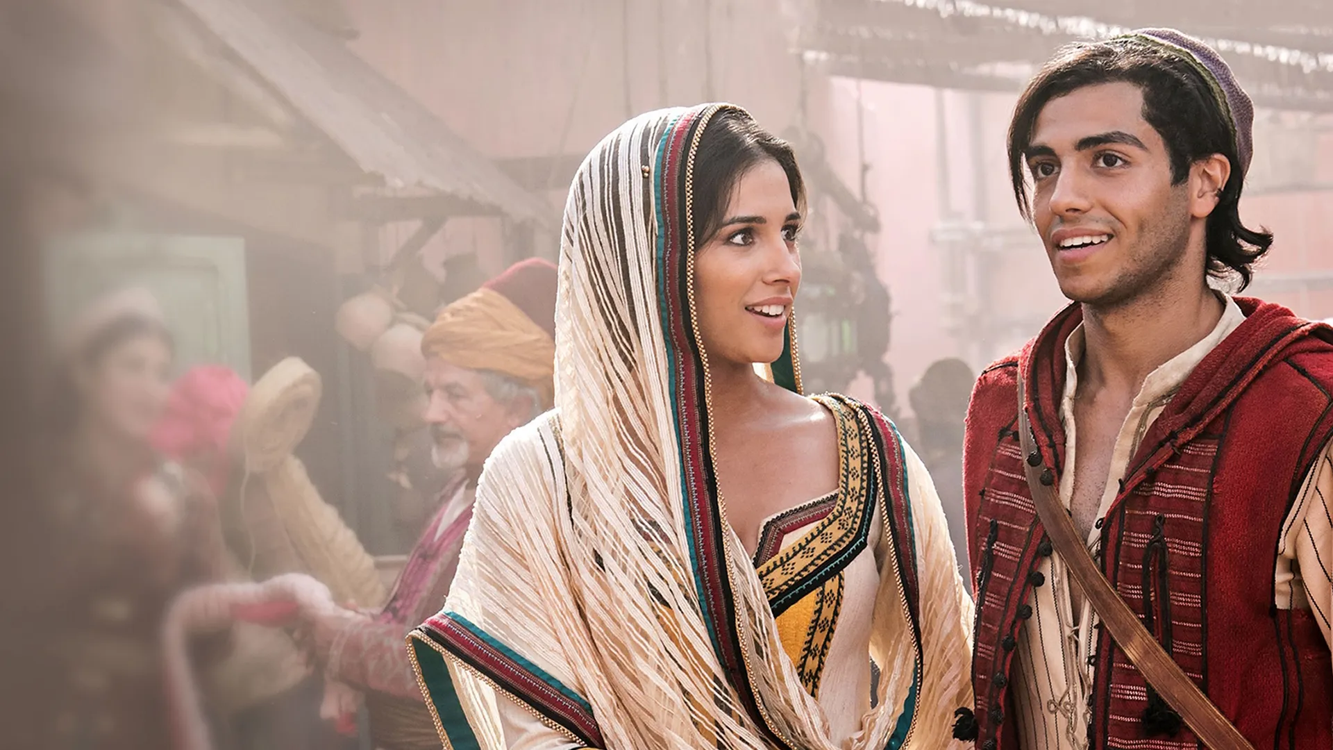 Naomi Scott as Princess Jasmine and Mena Massoud as Aladdin at the Agrabah market in Aladdin (2019)