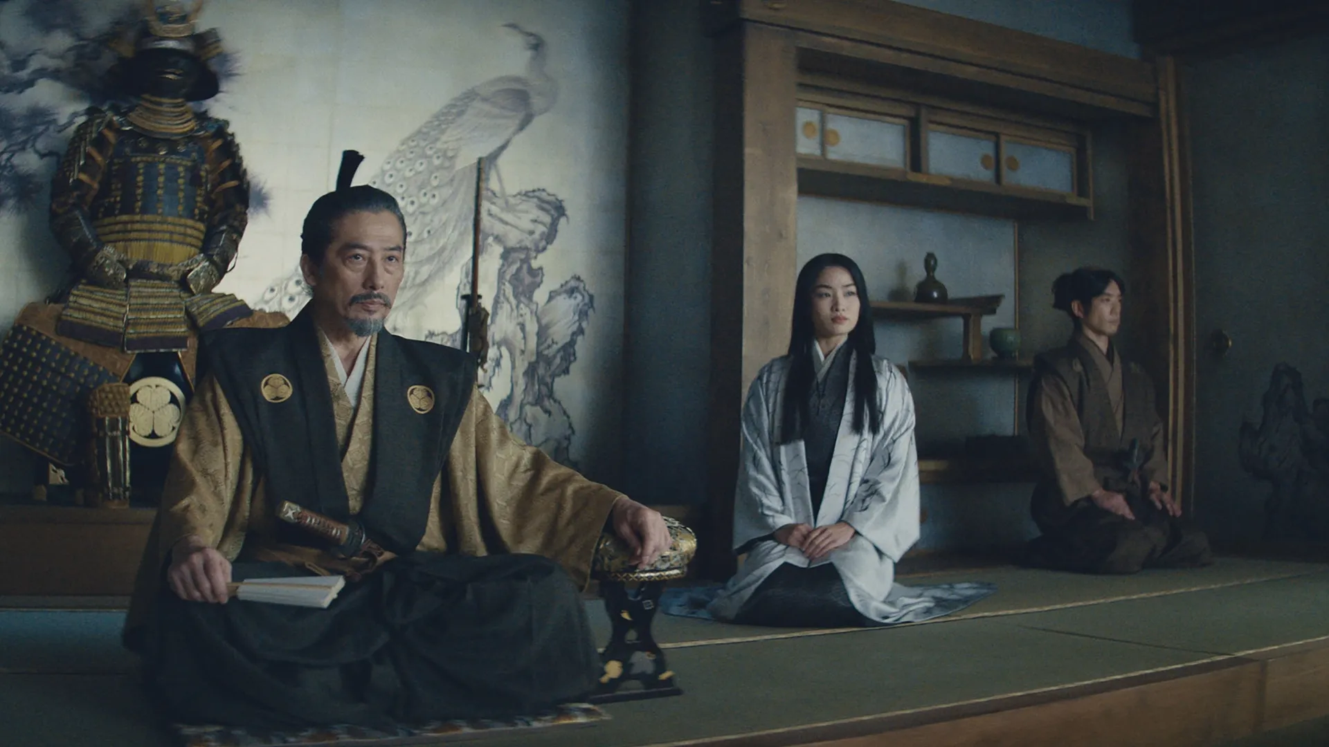 Lord Toranaga (Hiroyuki Sanada) sits with Mariko (Anna Sawai) seated off to the side.
