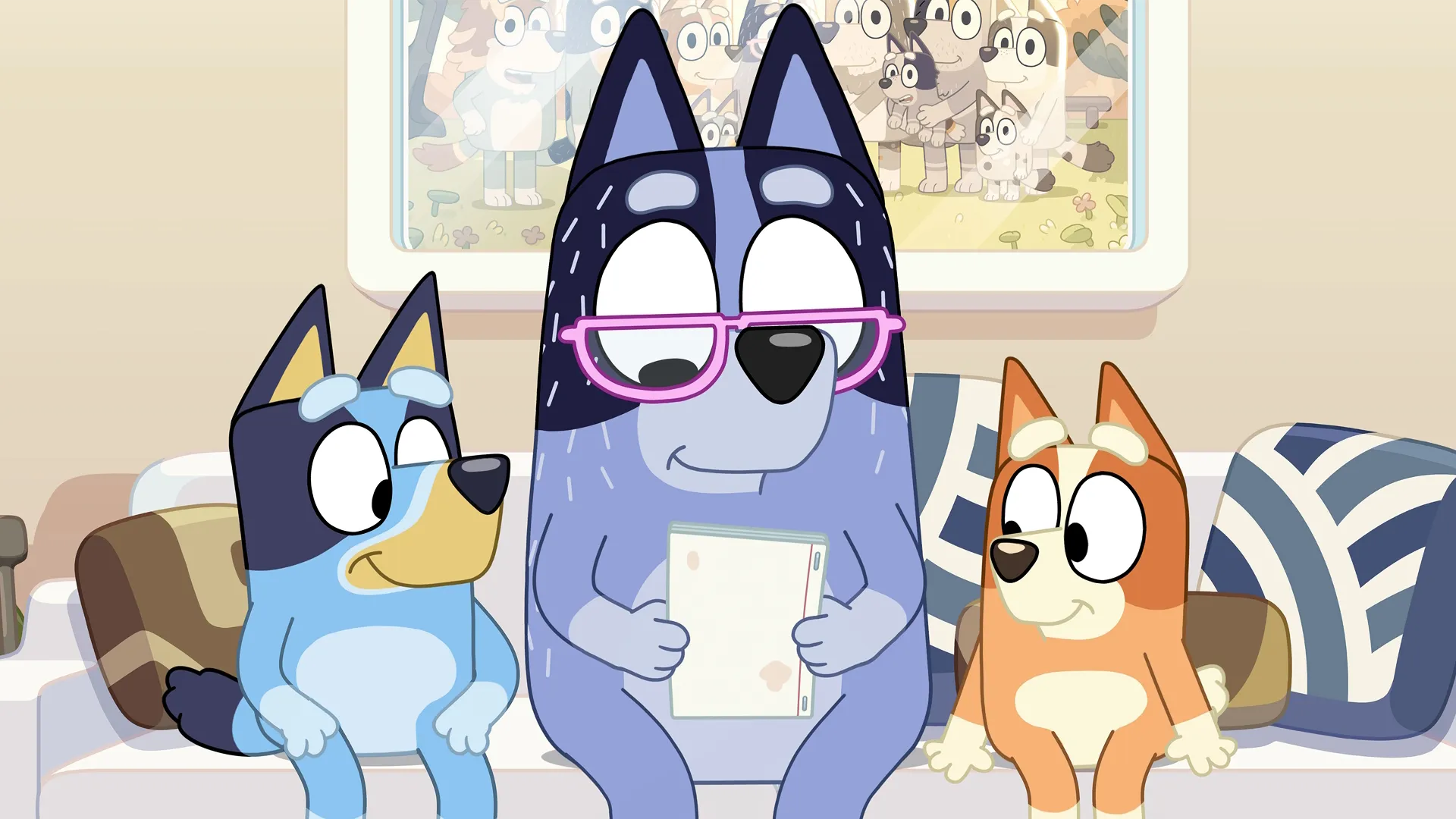 Bluey on the couch with her dad and sister.