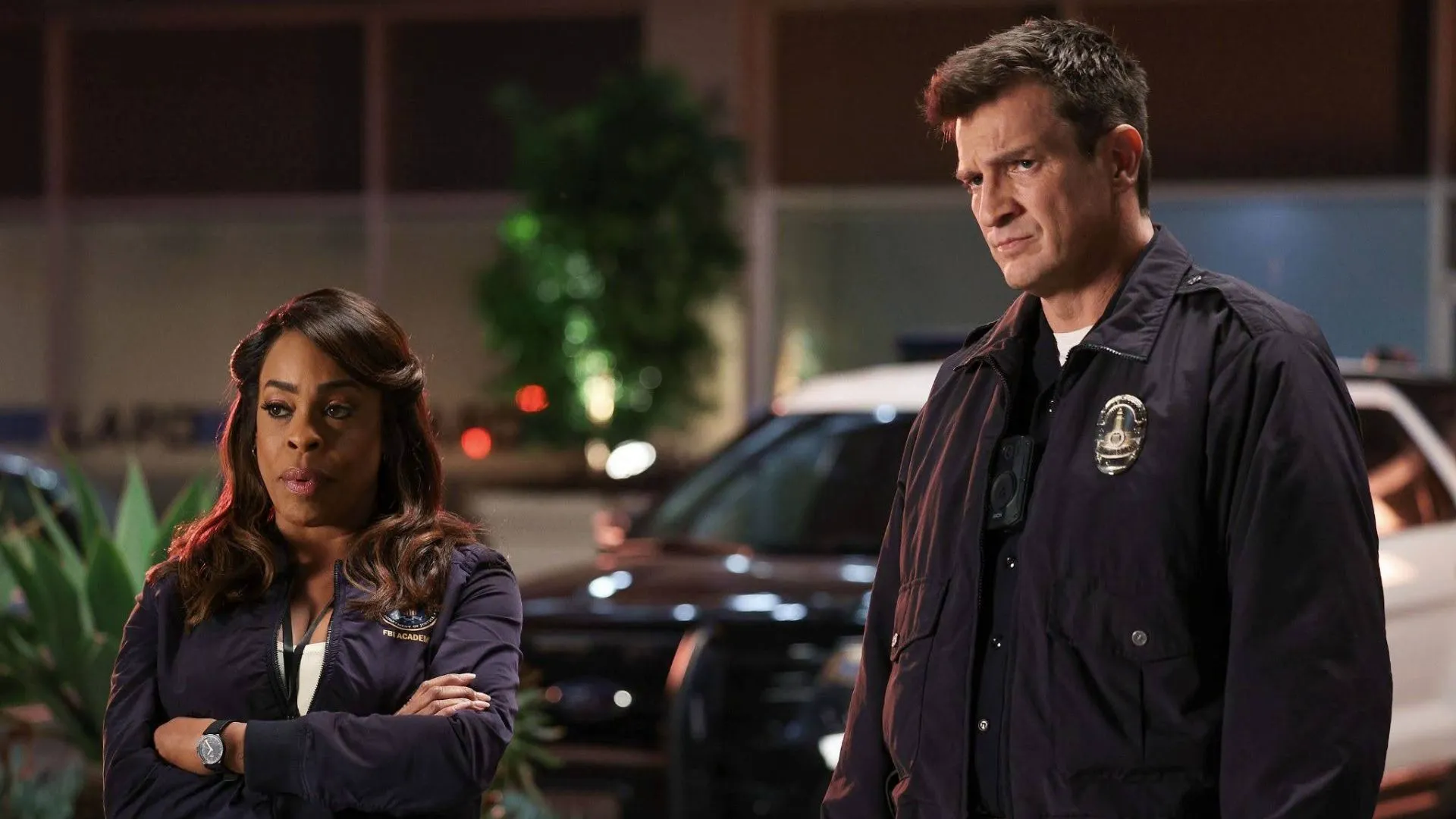 Simone Clark and Officer Nolan stand together at a nighttime crime scene