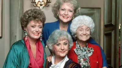 The Golden Girls beam as they pose for a group picture.