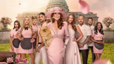 The cast of Vanderpump Villa stand in front of the Season 3 house. Lisa Vanderpump poses at the front with her pomeranian, Donut