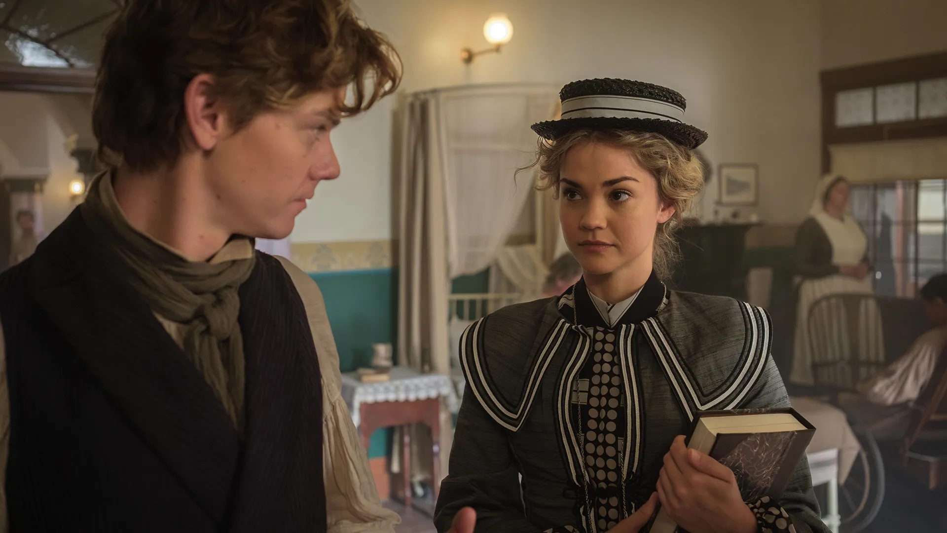Dr. Jack Dawkins (Thomas Brodie-Sangster) and Lady Belle Fox (Maia Mitchell) in the surgery, both characters are wearing Victorian era (1850's) clothing.