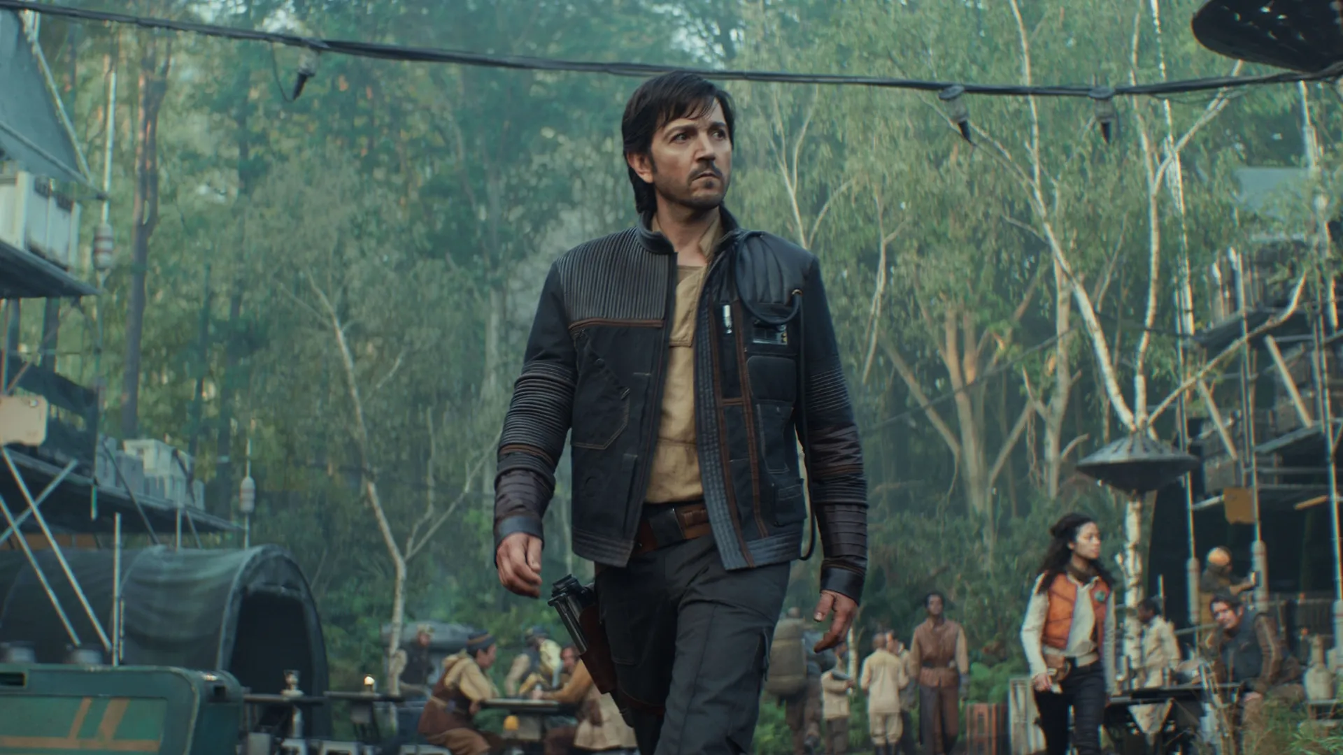 Cassian Andor (Diego Luna) walking through the Rebel base on Yavin 4.