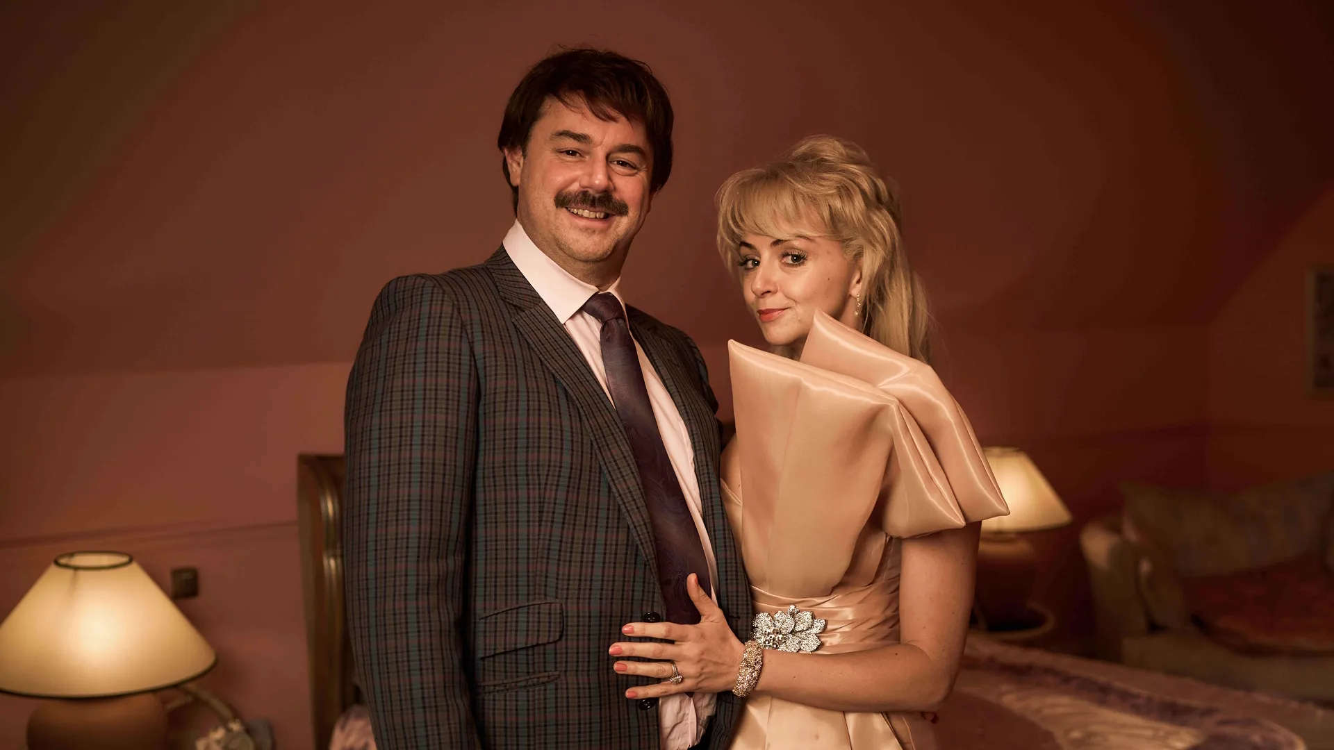 This image depicts Danny Dyer as Freddie Jones and Lisa McGrillis as Valerie Jones in the Disney+ series Rivals.