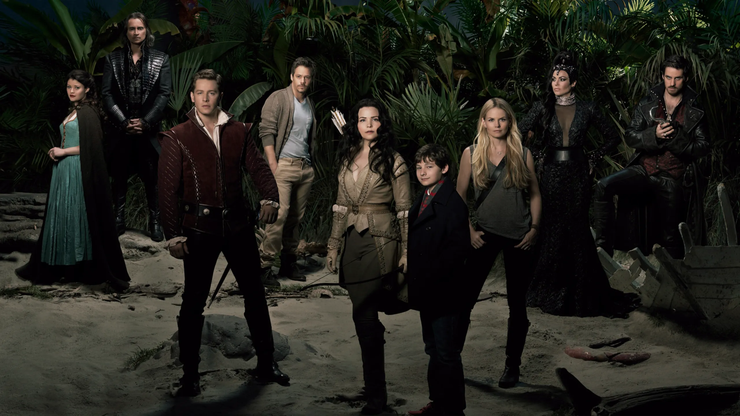 Cast of Once Upon a Time stood on a beach at night
