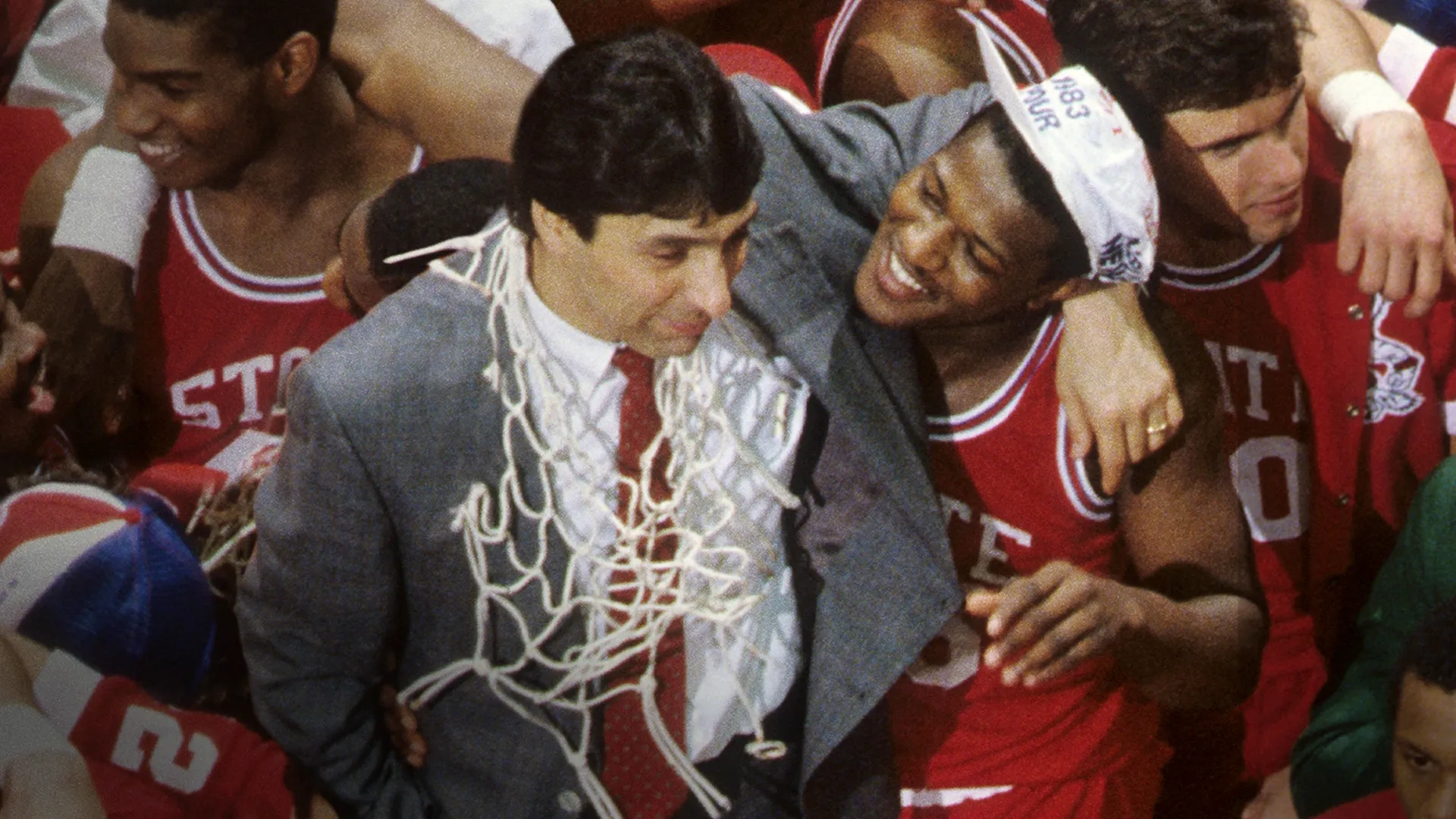 North Carolina State celebrate with coach, Jim Valvano, during their inspiring 1983 post-season.
