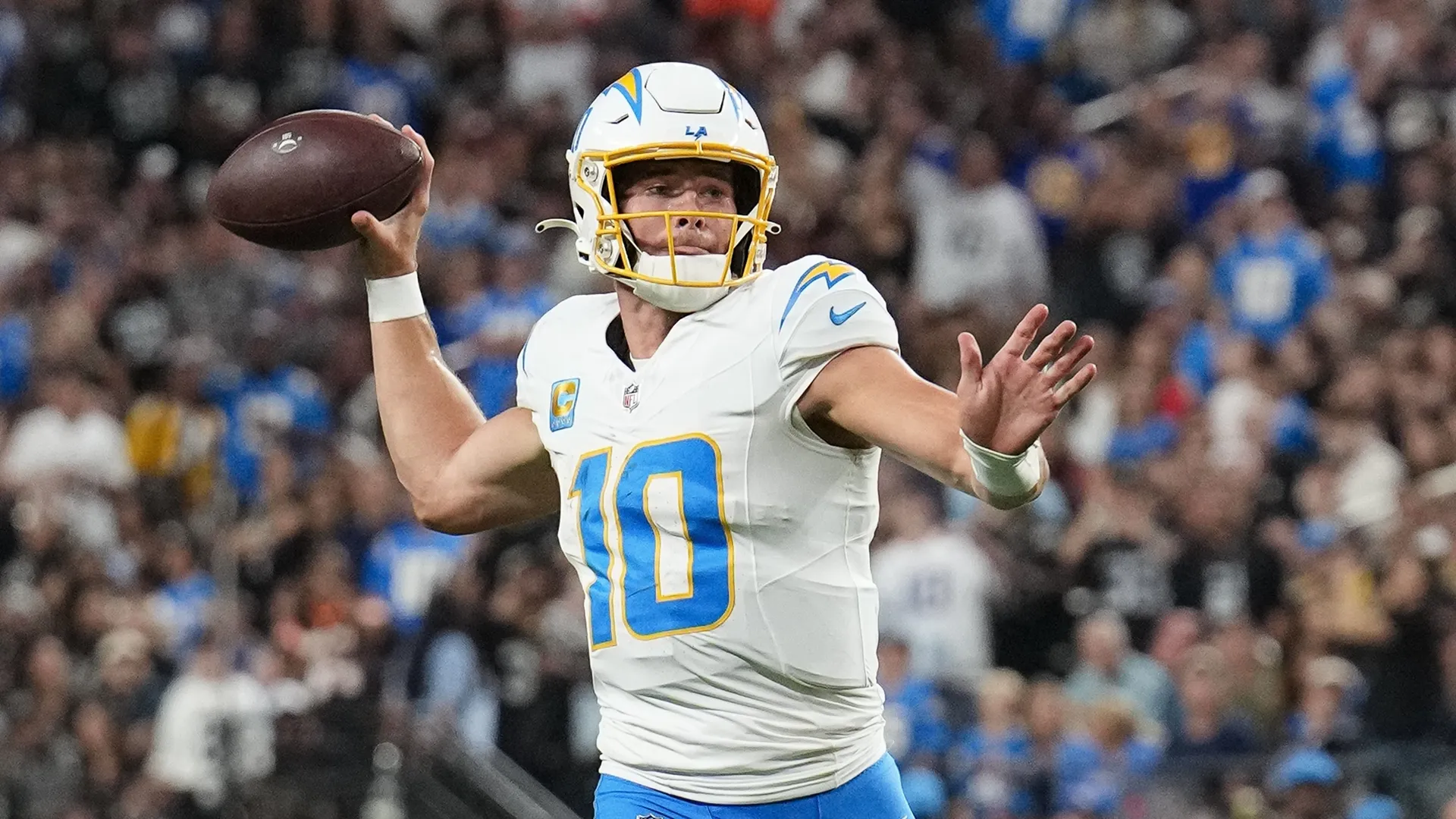 Justin Herbert, the quarterback for the Los Angeles Chargers prepares to throw the football.