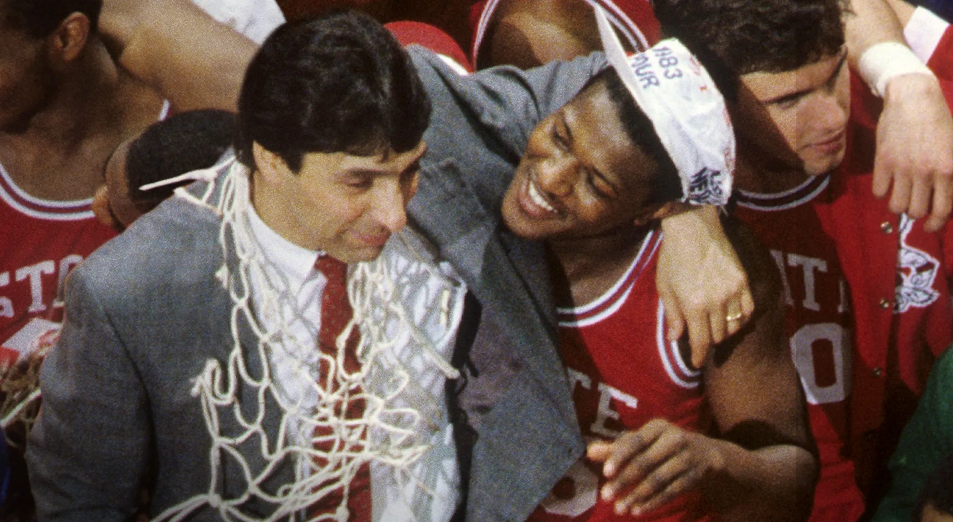 North Carolina State celebrate with coach, Jim Valvano, during their inspiring 1983 post-season.
