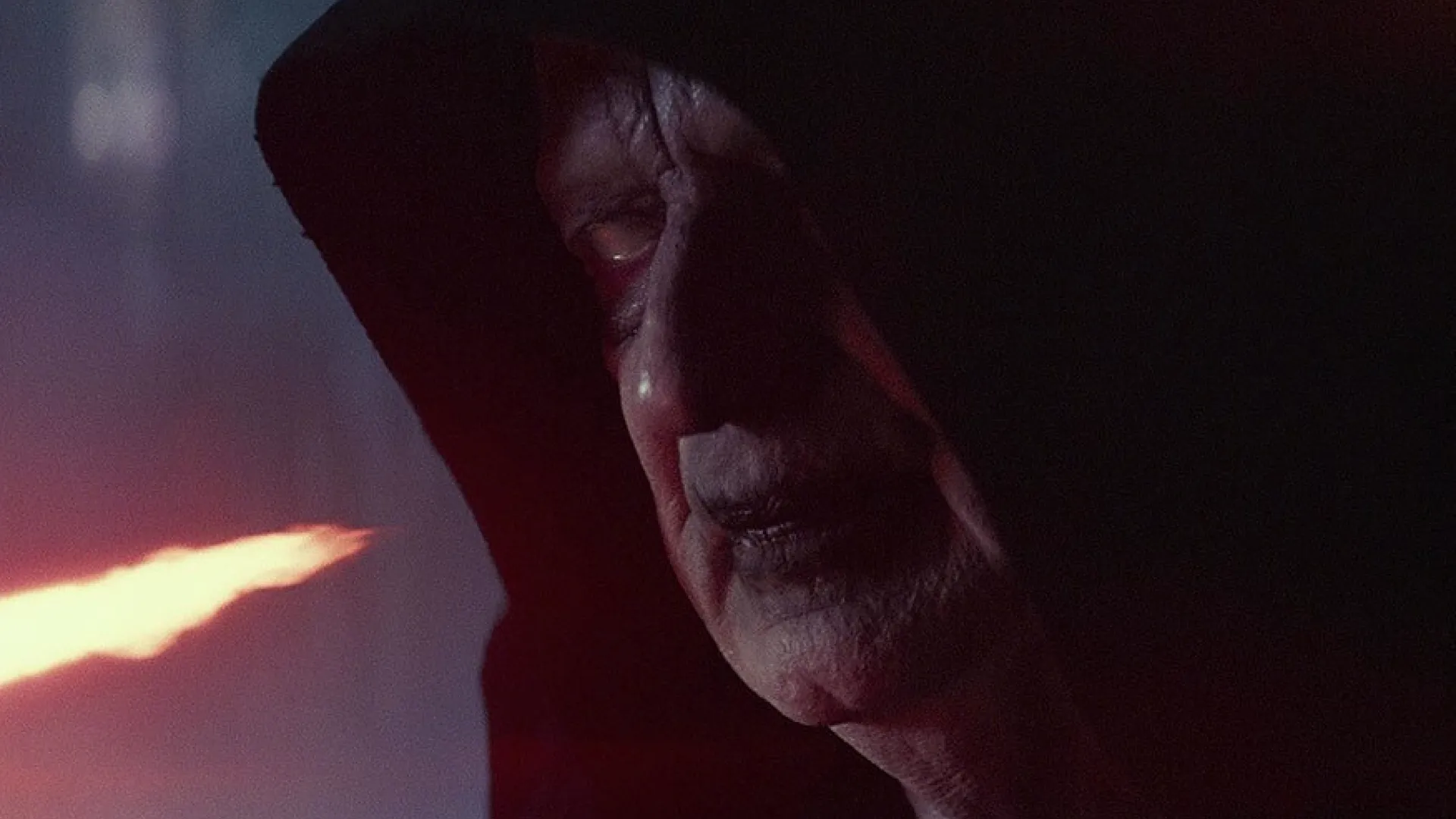 A closeup of Emperor Palpatine's face, hidden in the shadows of his cloak.