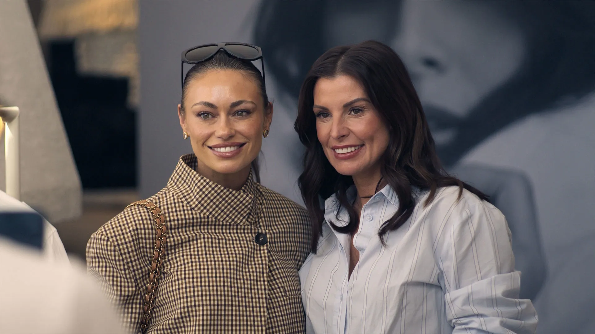 Coleen Rooney posing beside another person at an event in The Real Rooneys.