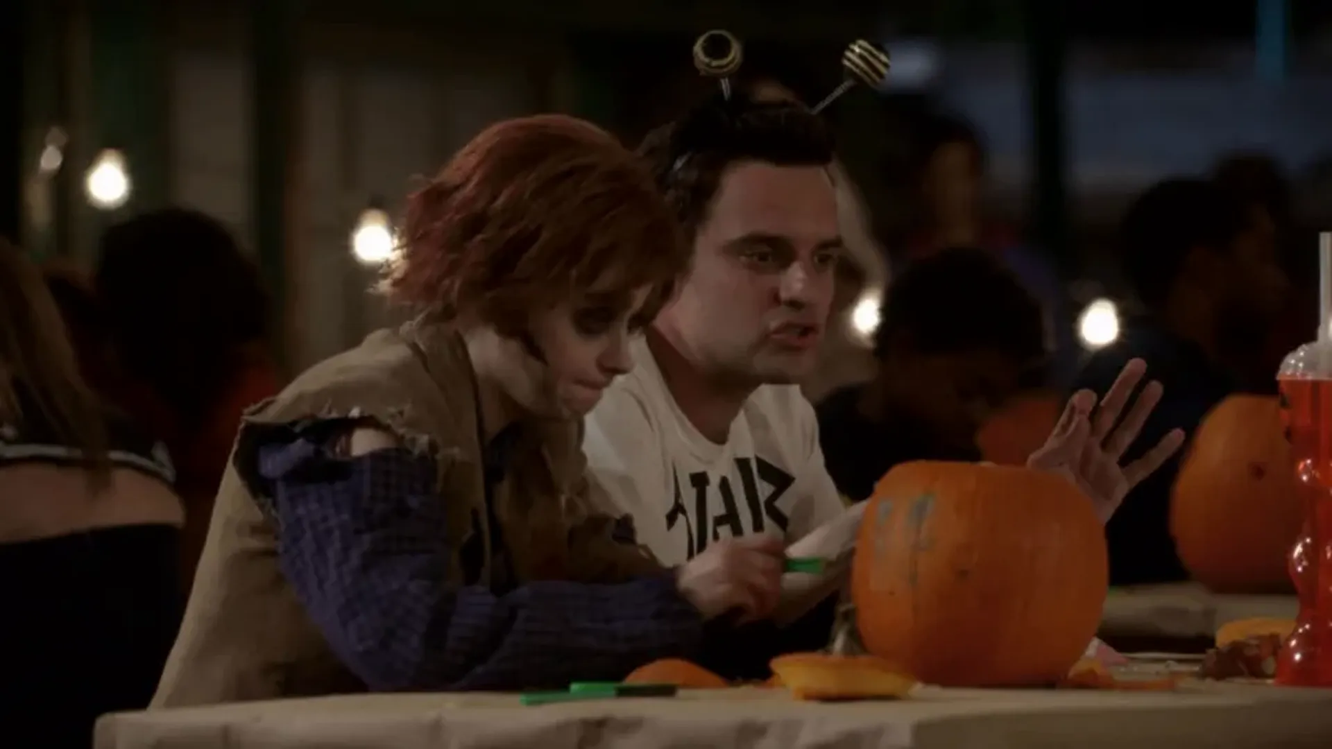 Jess (Zooey Deschanel) in her zombie costume and Nick (Jake Johnson) in his Bea Arthur costume in New Girl.