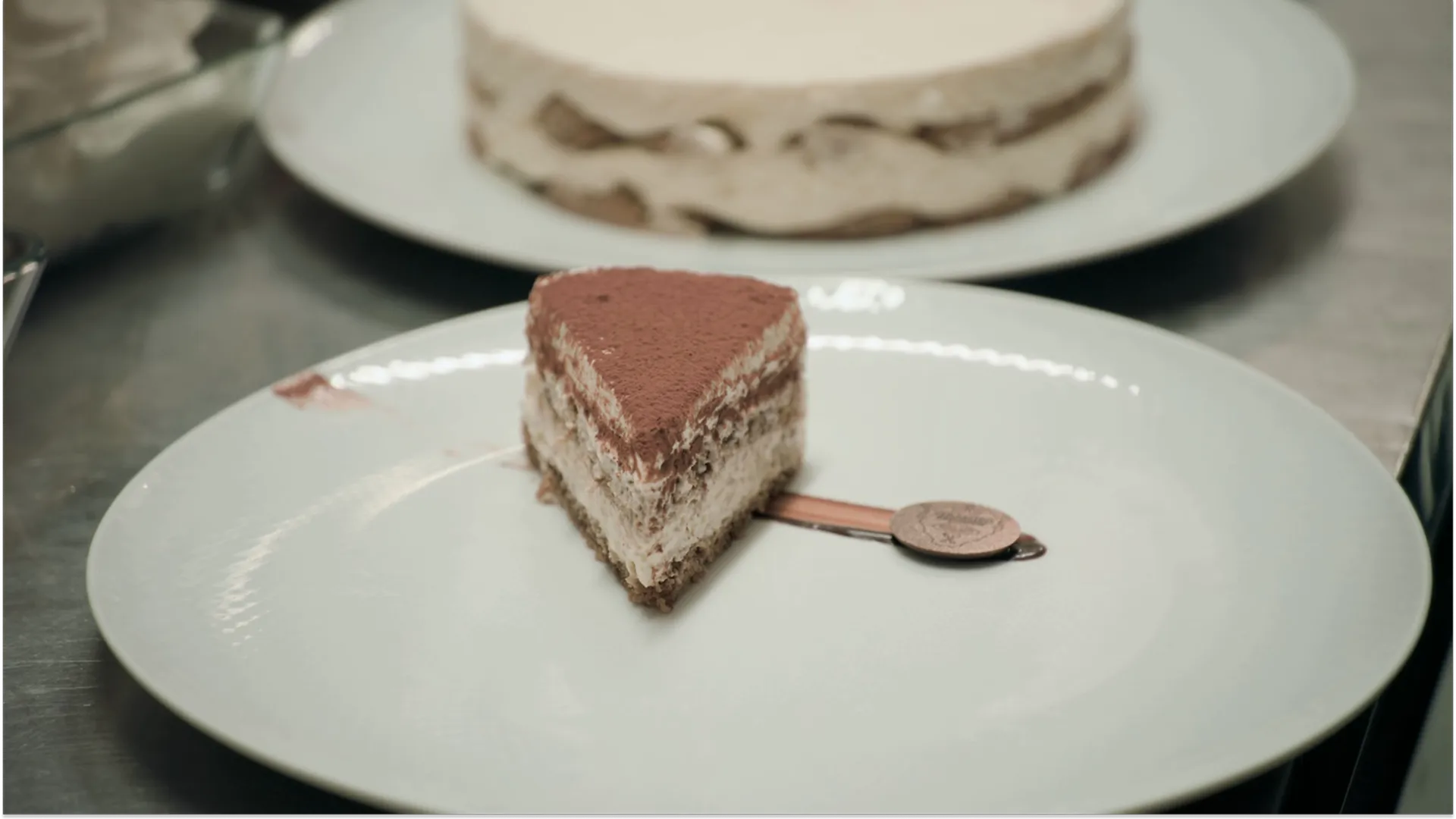A slice of tiramisu on a white plate