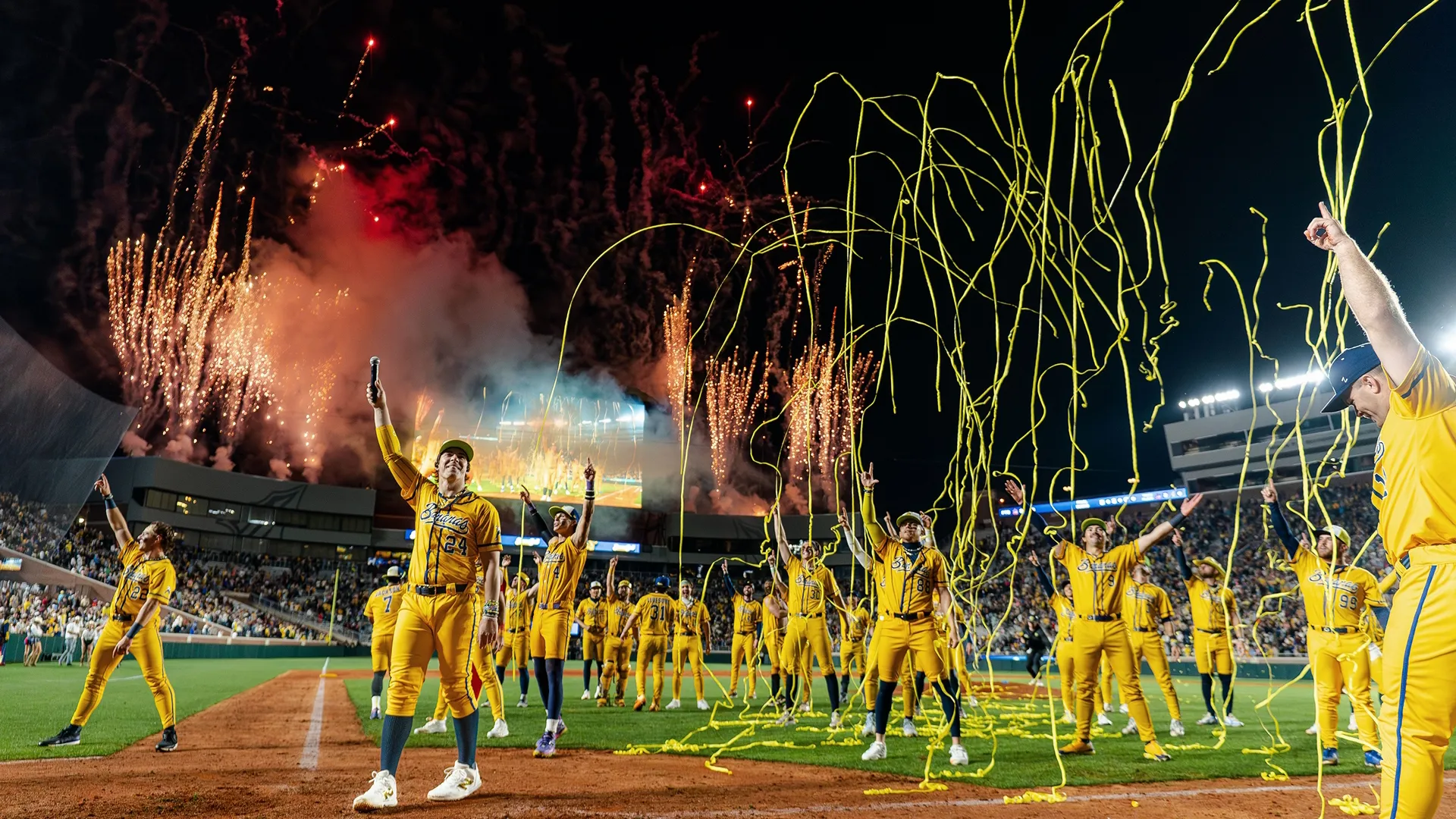 The Savannah Bananas baseball team celebrating on the field during a Banana Ball game under a shower of confetti and streamers