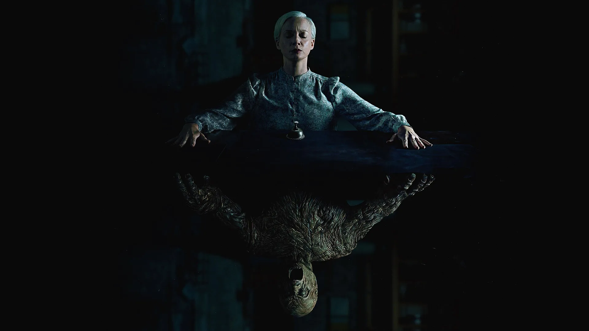 A woman sitting at a table, reflected in the table is a monster instead of the woman herself