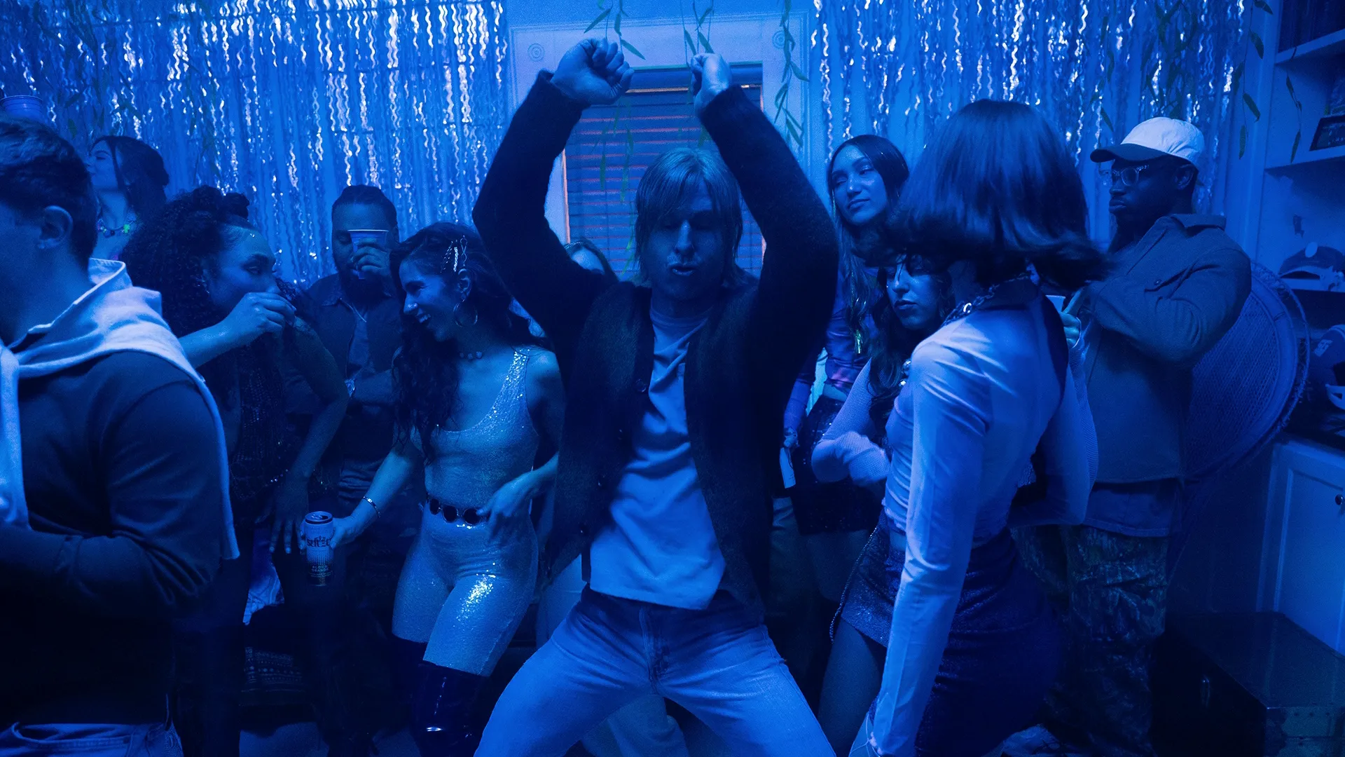 Glen Powell as Russ Holliday dancing at a party in Chad Powers