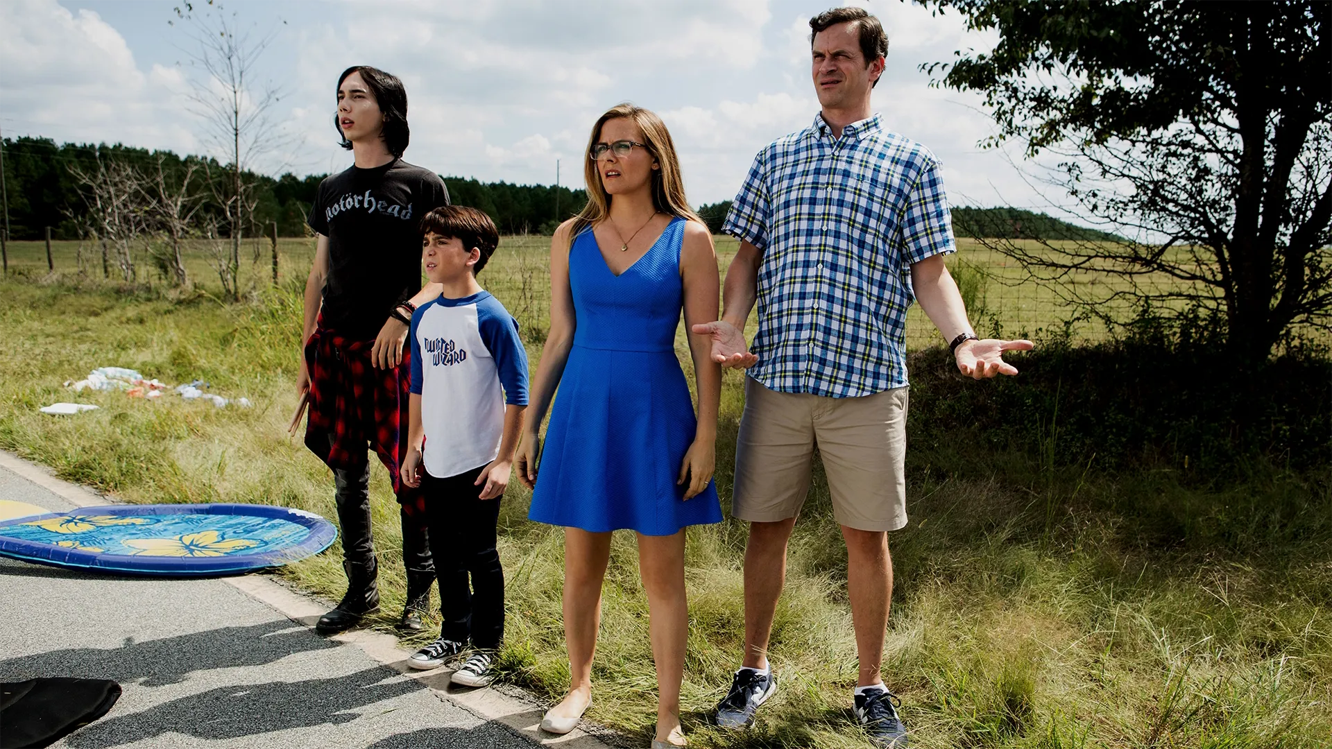 A confused Heffley family standing at the roadside. (L-R:) Rodrick (Charlie Wright), Greg (Jason Drucker), Susan (Alicia Silversone, and Frank (Tom Everett Scott).
