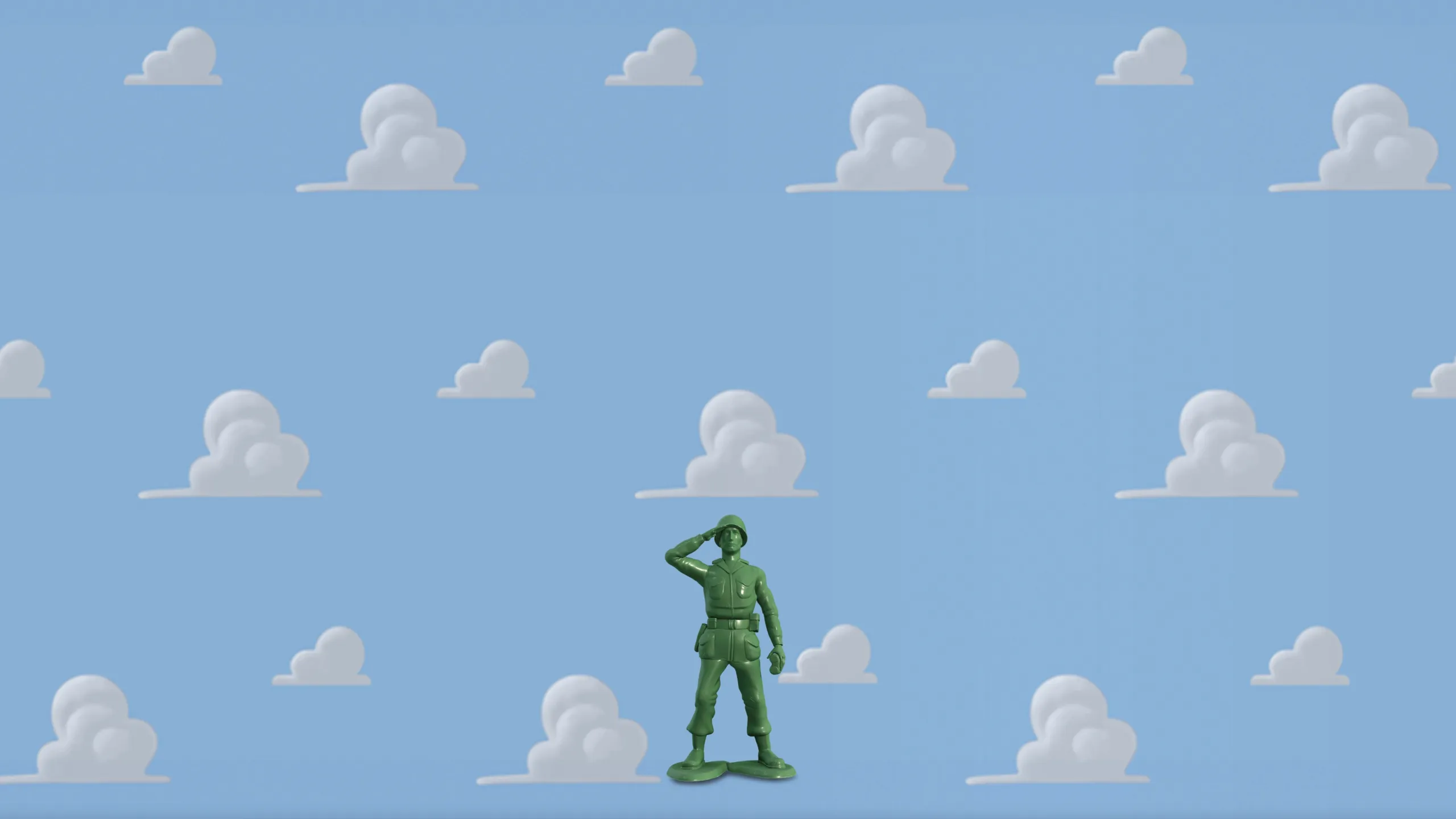 A miniature green army man toy saluting