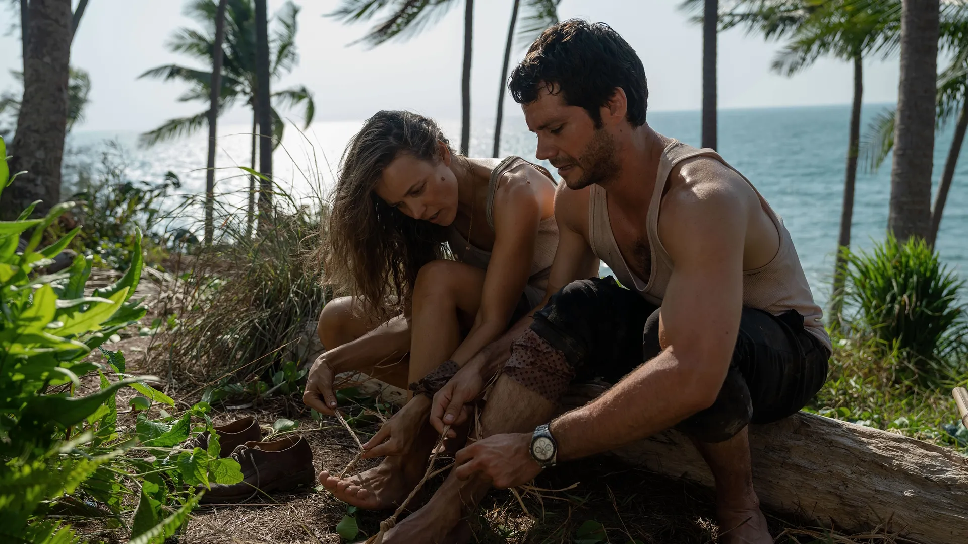 Rachel McAdams (left) and Dylan O'Brien (right) stranded on a deserted island in a scene of Send Help, Disney+
