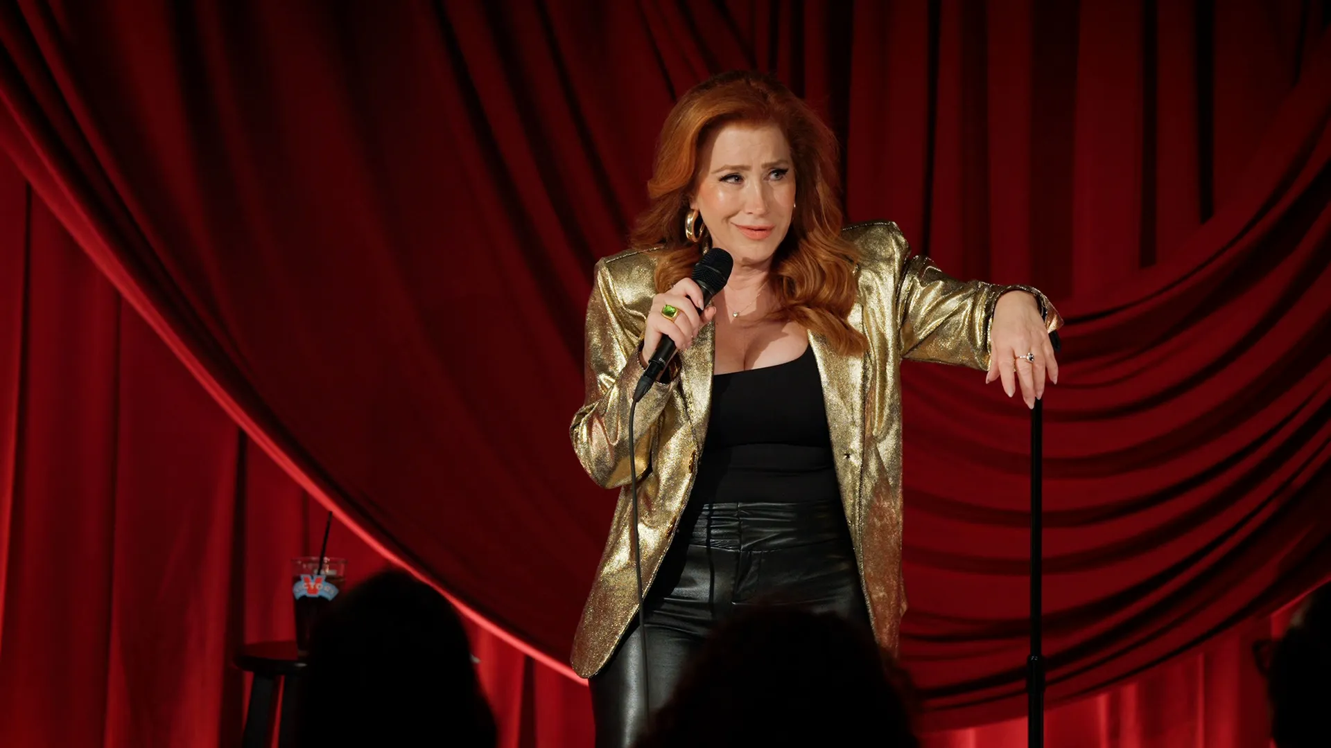 This image features actress and comedian Lisa Ann Walter on stage during a performance. Walter is set to release her debut stand-up comedy special, titled Lisa Ann Walter: It Was an Accident, on Hulu.