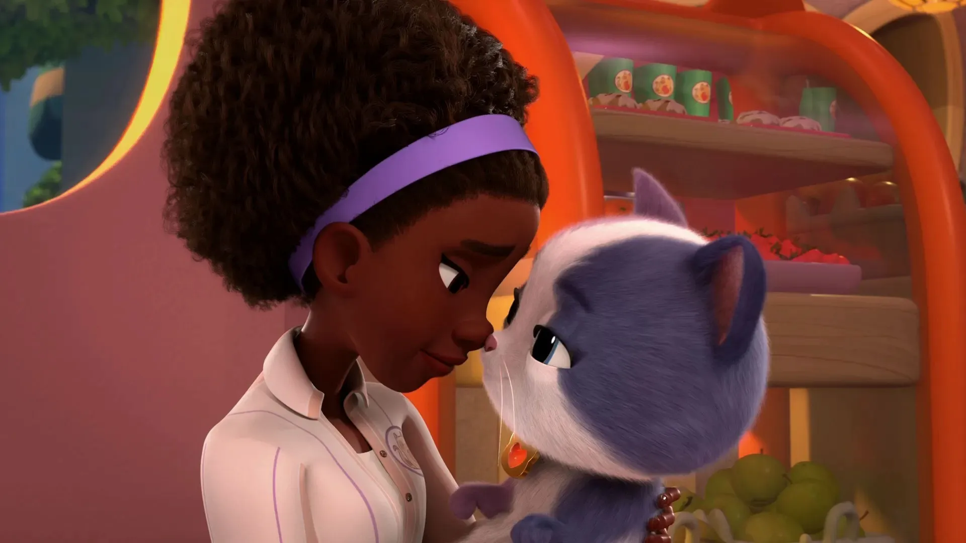 Amara, who cares for the kittens at the Purr 'n Play, holds one of the SuperKitties in her arms.