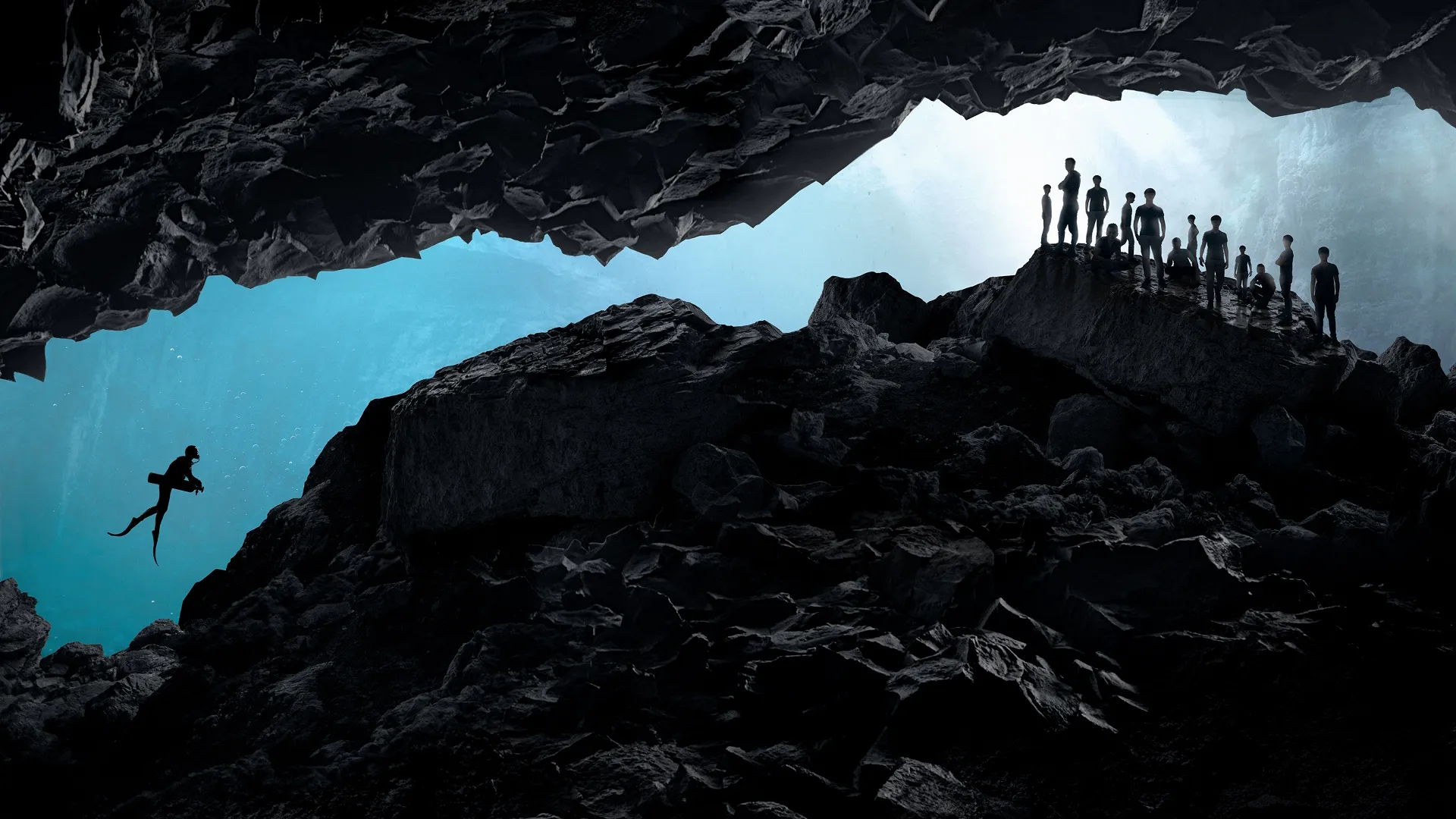 A photo showing a rescue diver on one end of a cave, and the you Thai soccer players on the other end