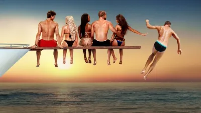 Love Overboard contestants sitting on a long diving board at the nose of a yacht with one man being pushed off the end.