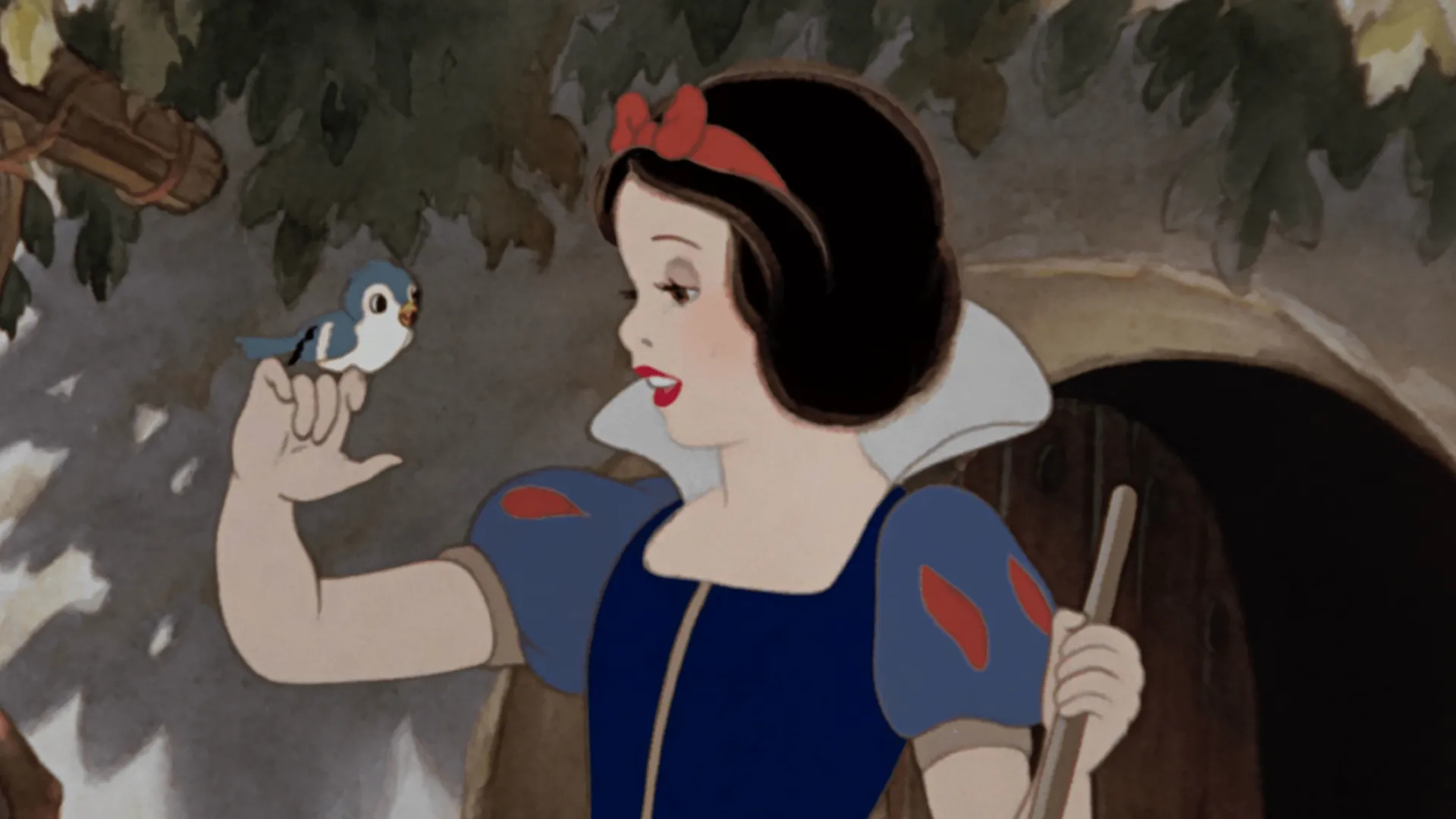 Snow White smiles as a small blue bird perches on her raised hand.