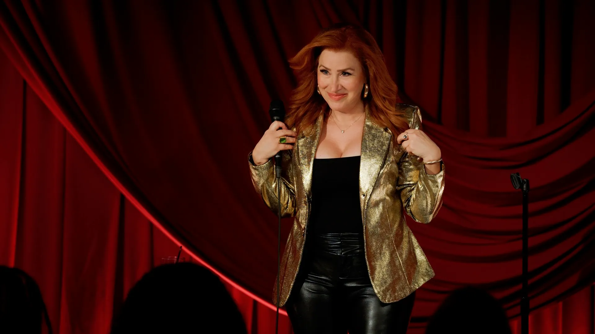 This image shows actor and comedian Lisa Ann Walter on stage during one of her stand-up comedy performances.
