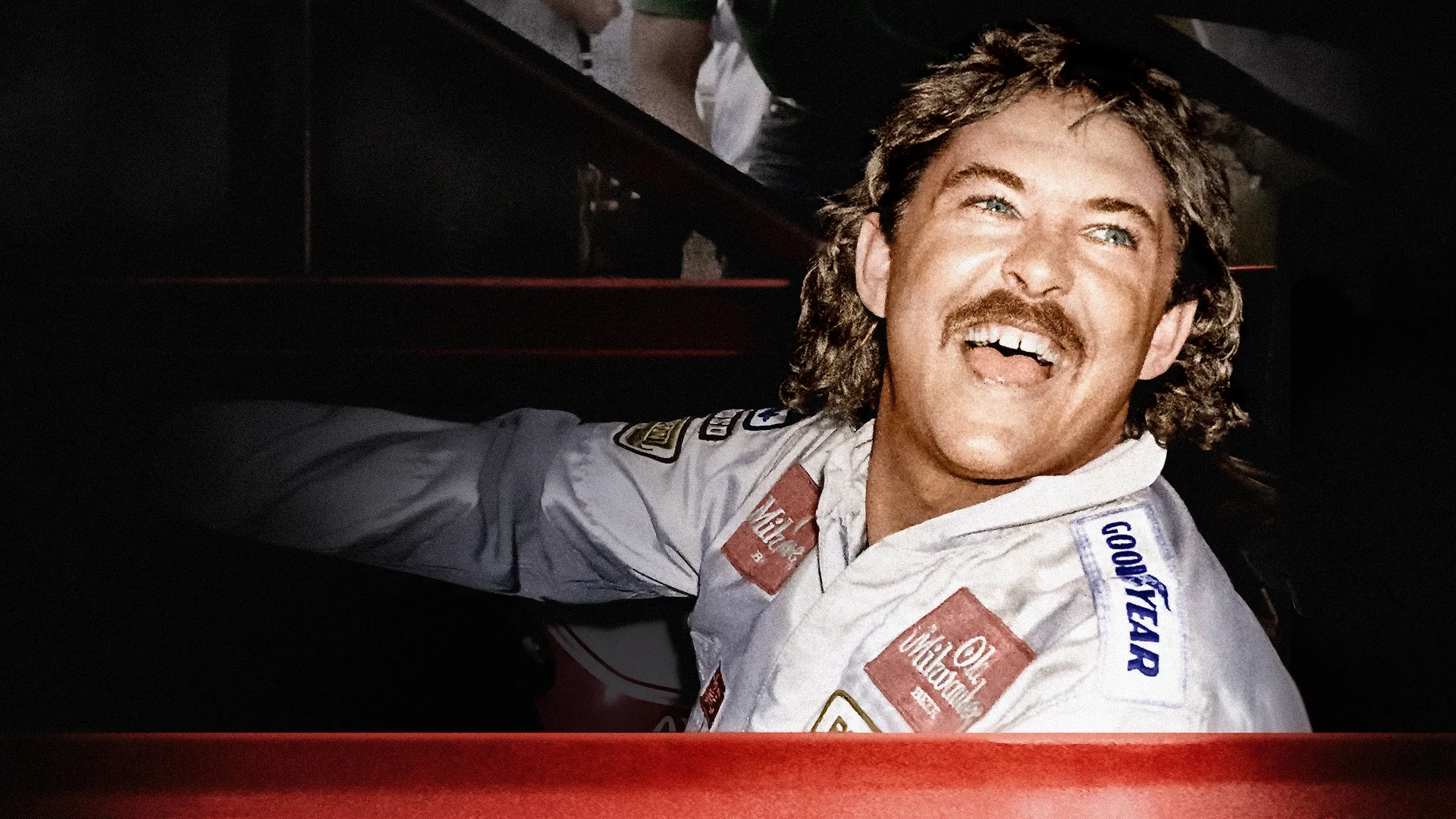 This image shows American race car driver Tim Richmond, a flamboyant NASCAR star known for his daring driving style in the 1980s.