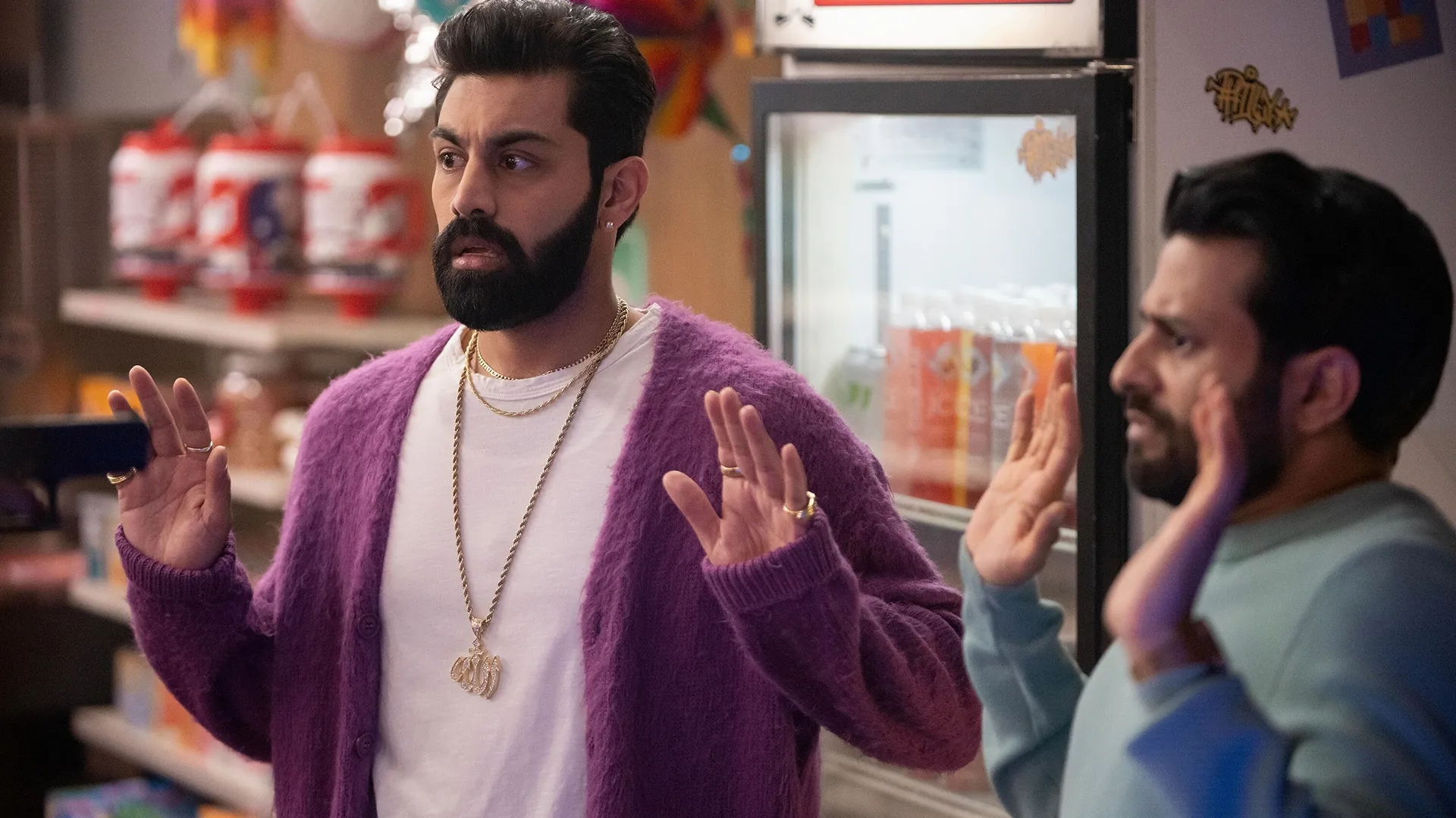 Mir (Asif Ali) and Raj (Saagar Shaikh) are held at gunpoint inside the deli store.