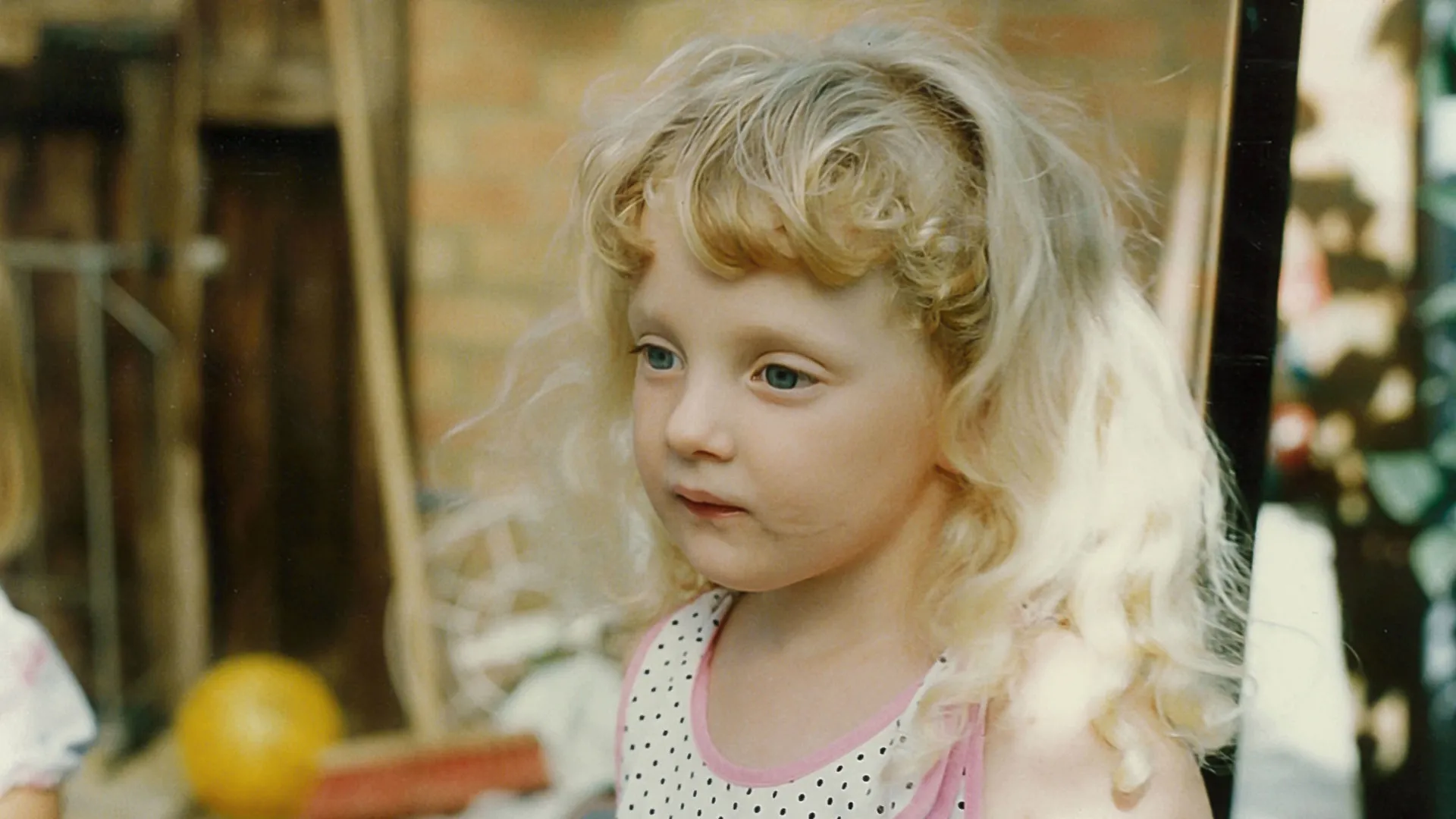 Key art for Manhunt: Where Is Danielle? featuring a childhood photograph of a young child outdoors.