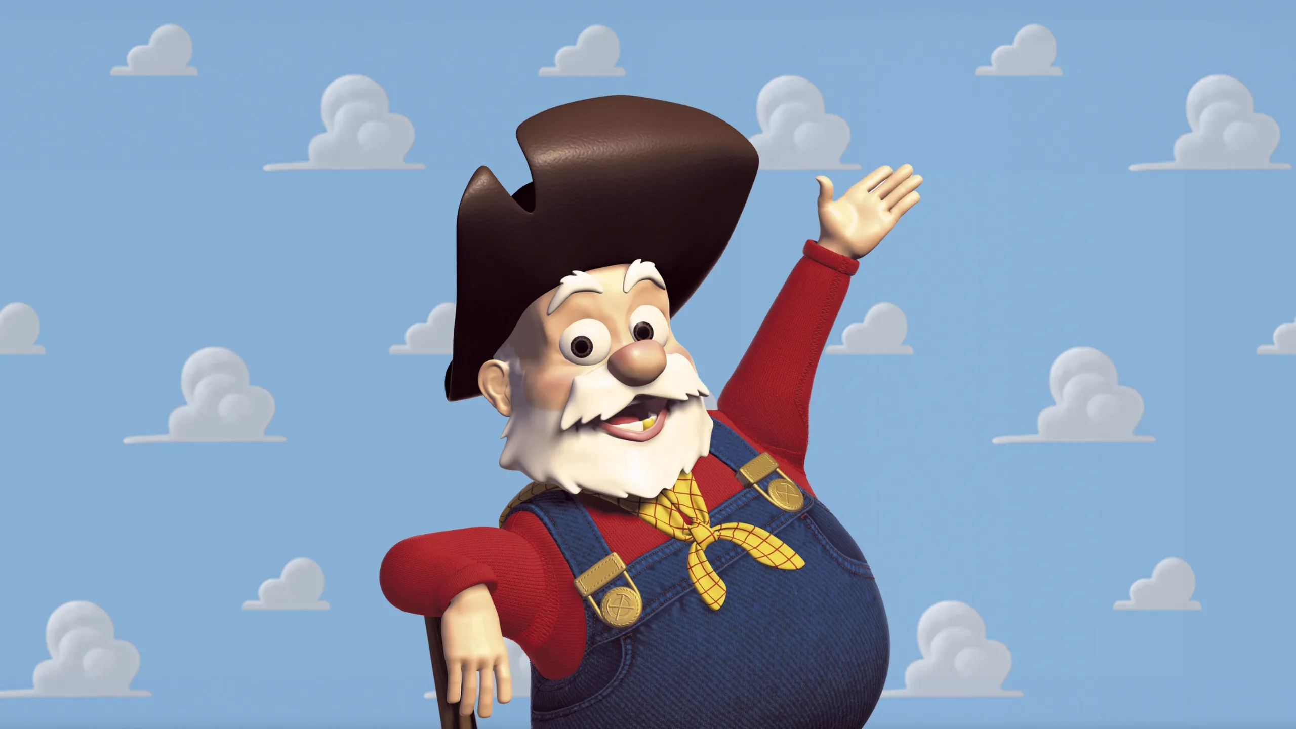 A vintage prospector doll wearing a red shirt and denim dungarees