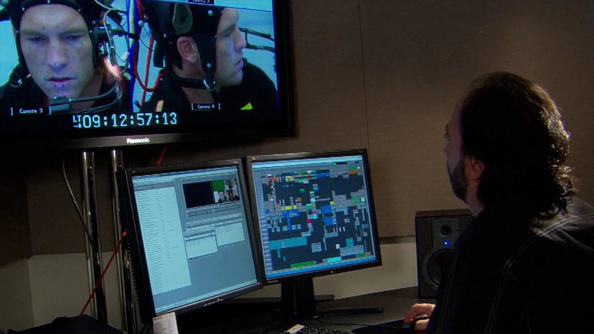 A man works on motion capturing on a dual-monitor computer.