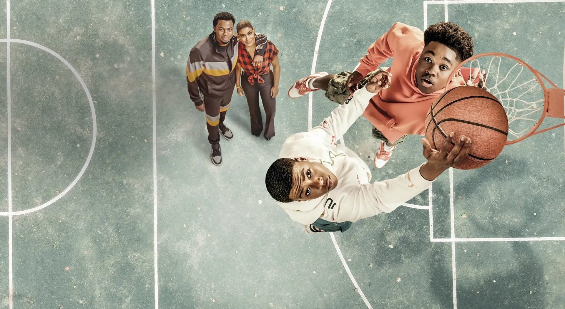 Brothers Josh (Jalyn Hall) and Jordan Bell (Amir O'Neil) are in mid-air trying to dunk a basketball as their parents watch on.