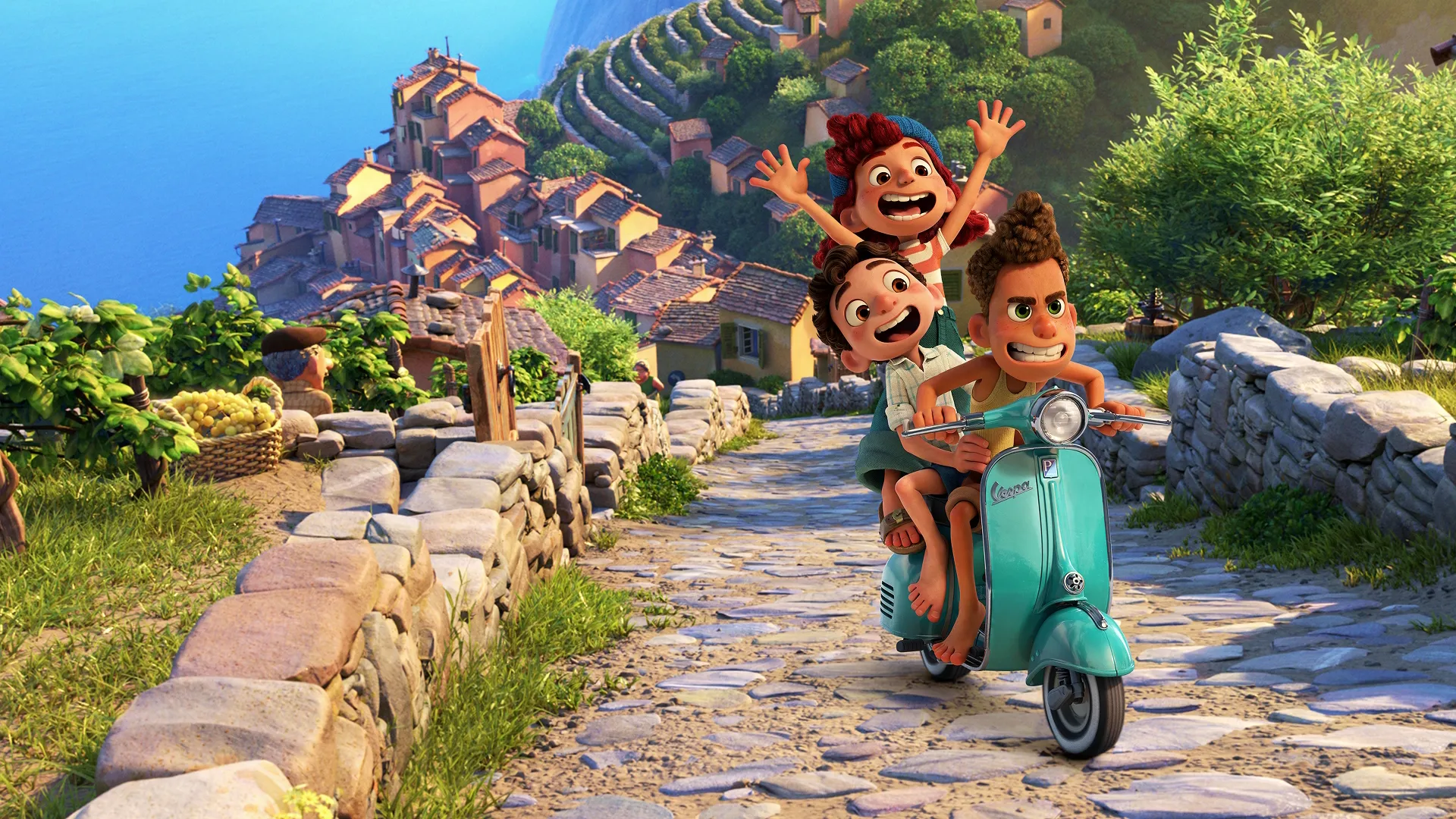 Three excited children ride together down a cobblestone hill path on a classic teal Vespa scooter, with a scenic Italian coastal town and the blue ocean stretching out in the background, in a still from the animated movie Luca.