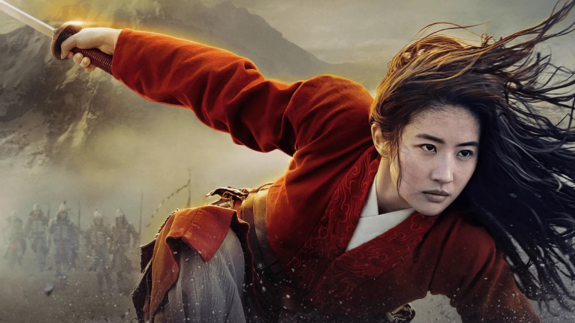 Mulan (Yifei Liu) crouches forward with an intense expression, her long dark hair flowing in the wind, as she dynamically wields a sword with her right arm extended while a line of soldiers marches behind her against a smoky, mountainous backdrop.
