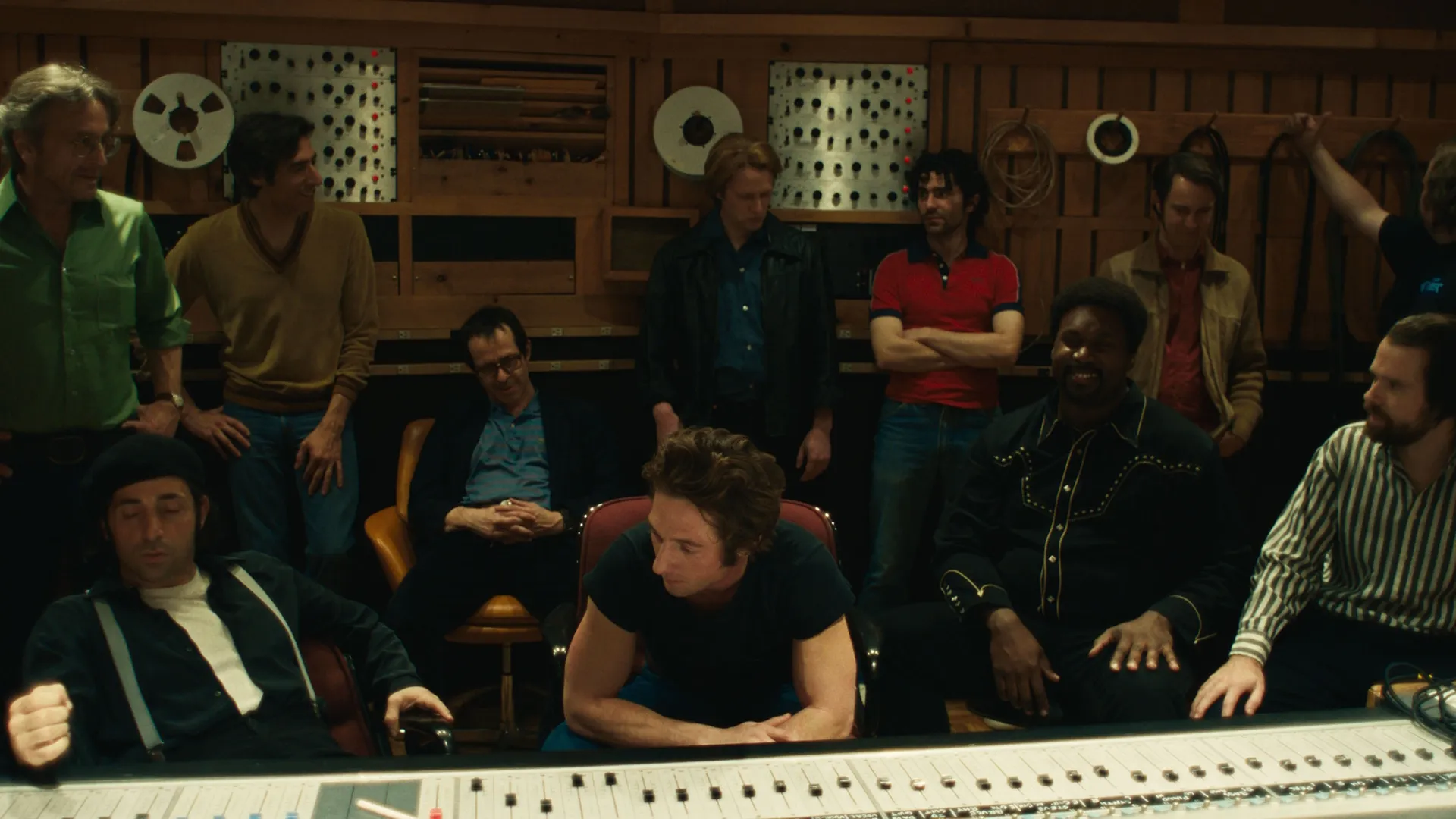 Bruce Springsteen (Jeremy Allen White) sits in a recording studio surrounded by other characters.
