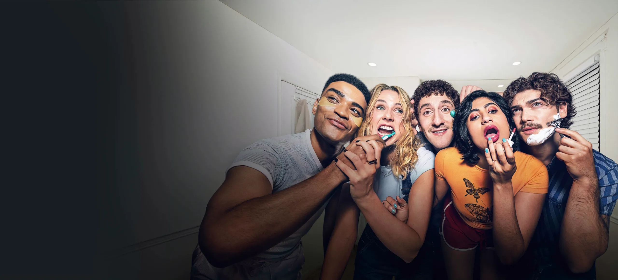 Key art for Adults Season 2, featuring a group of friends crowded together in a bathroom, getting ready in front of a mirror in a comedic everyday moment.