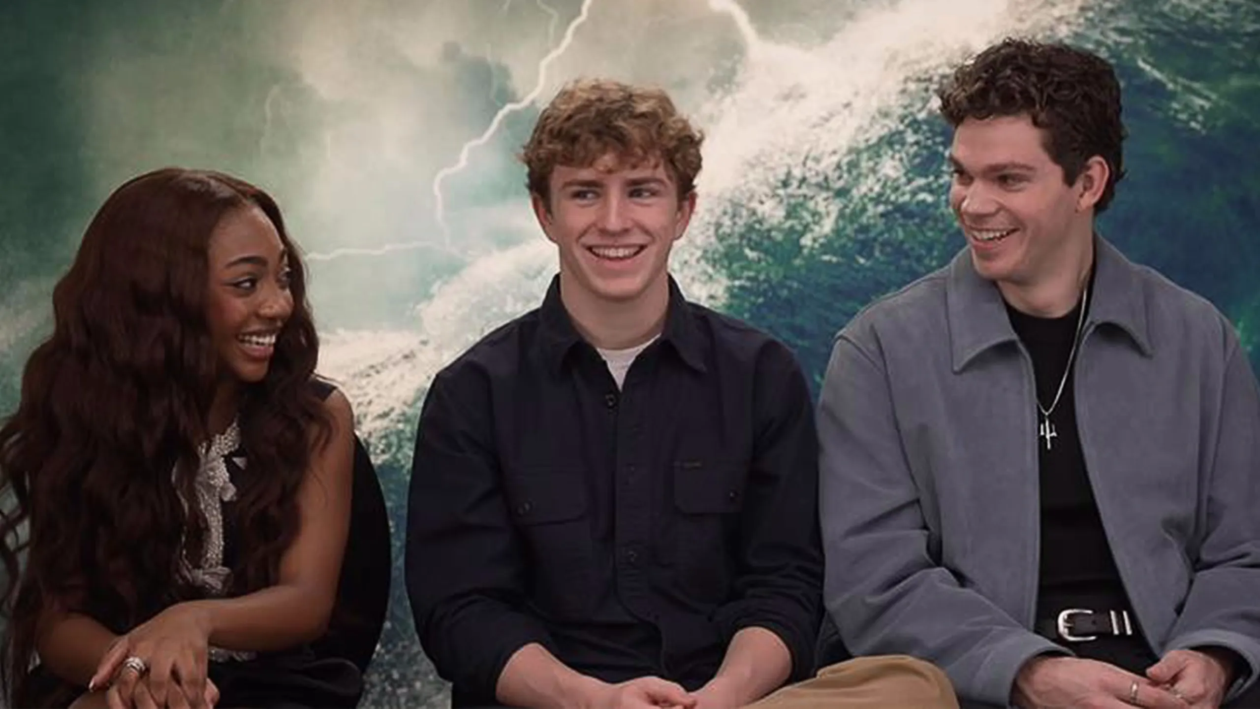 Percy Jackson and The Olympians cast members Leah Jeffries, Walker Scobell, and Daniel Diemer sat for an interview, with an ocean waves background